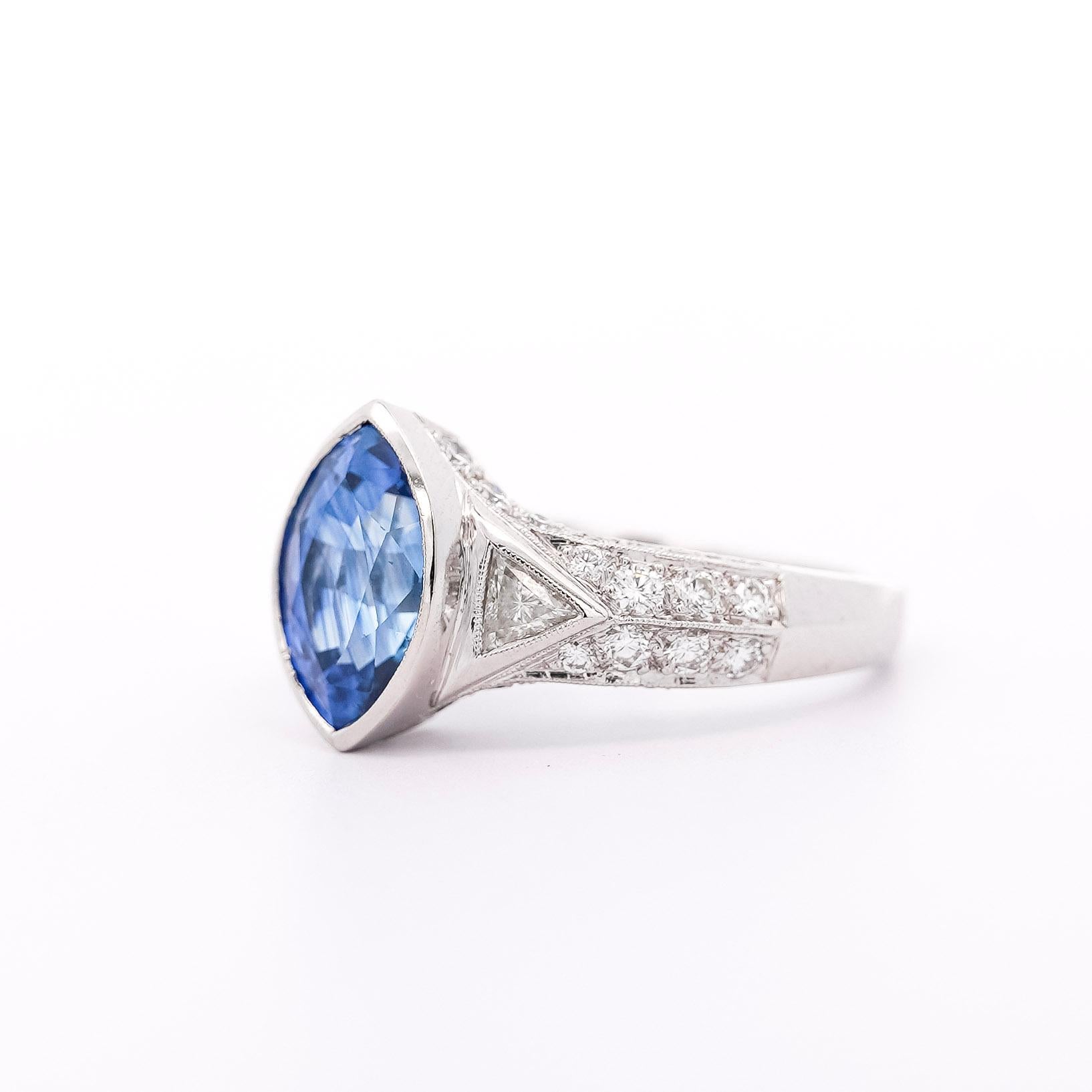 GIA Certified Vintage Sapphire and Diamond Platinum Ring. Ideal as a man's pinky ring or a woman's statement/engagement ring. 

This timeless ring features a marquise-cut blue Sapphire originating from Sri Lanka, it weighs 4 carats, and is of Sri