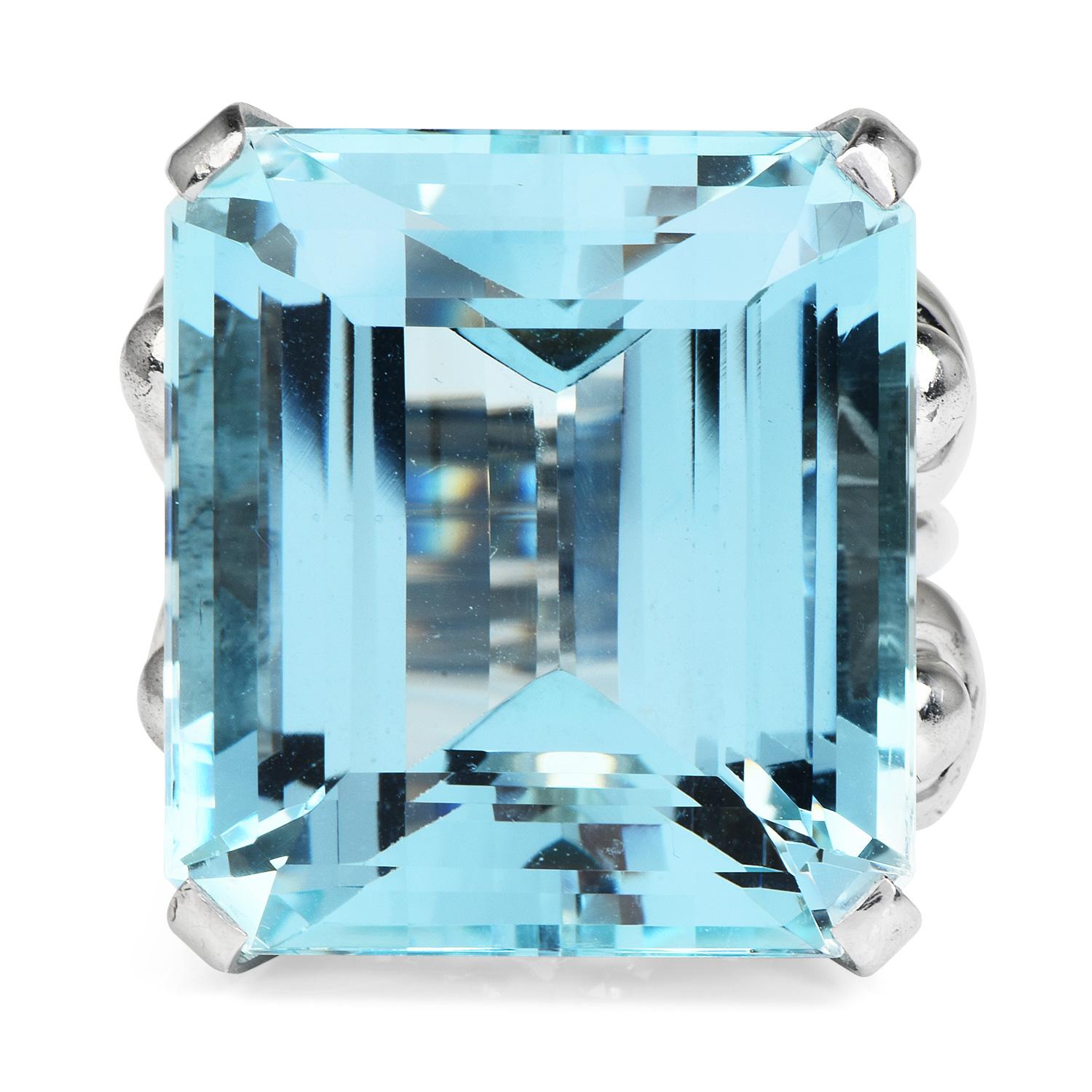 This vivacious 1950's vintage ring will captivate anyone

who sees it.  It is centered with a rare rectangular GIA Certified Aquamarine

weighing approx 47.02 carats to the Retro channeled design of the shank.

Aquamarine measures appx. 23.04 x