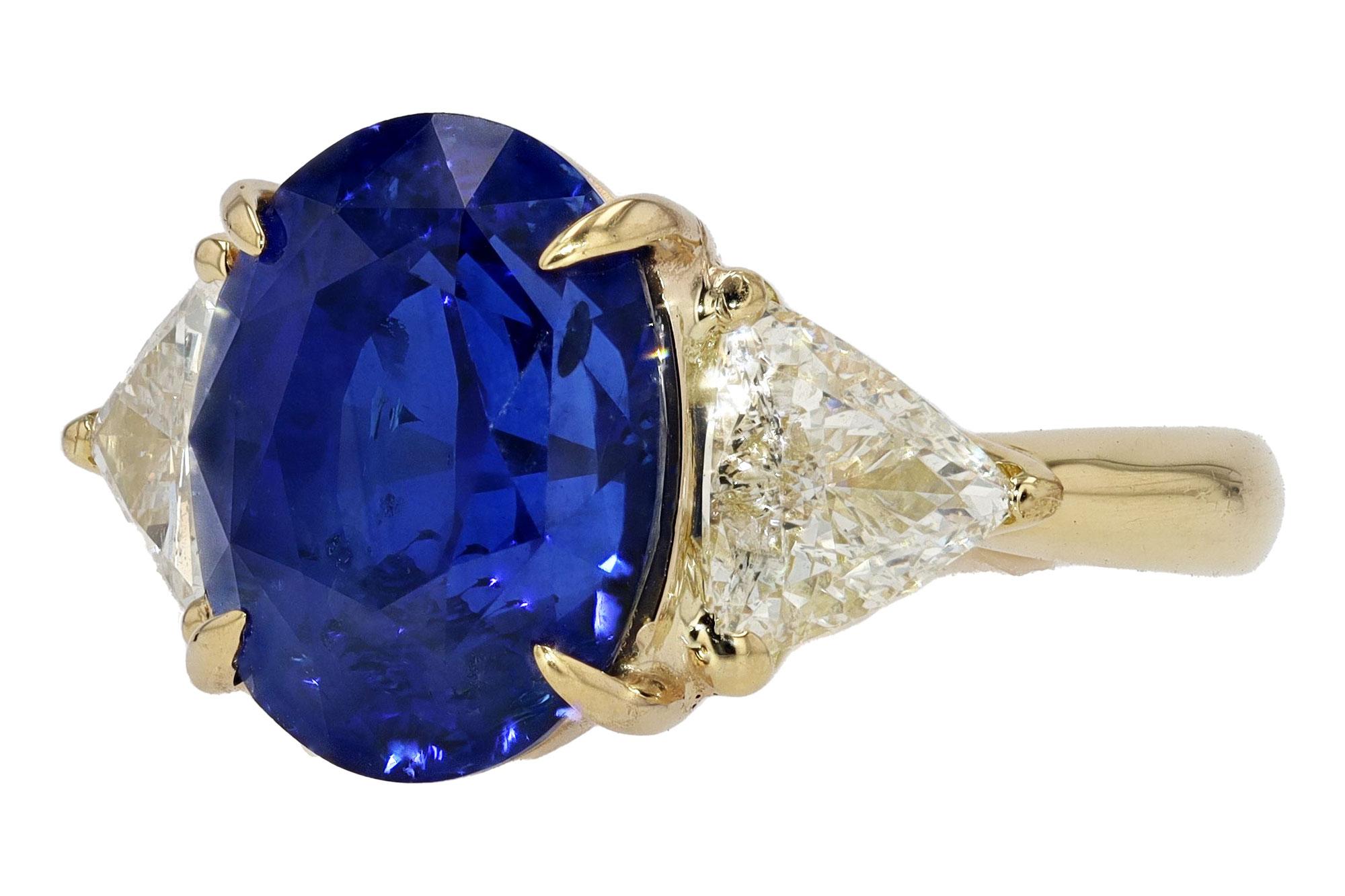 A classic 3 stone sapphire engagement ring centered by a rich, royal blue Ceylon sapphire. A gem of notable pedigree along with a Gemological Institute of America {GIA} report stating both identity and origin. What makes this gemstone engagement