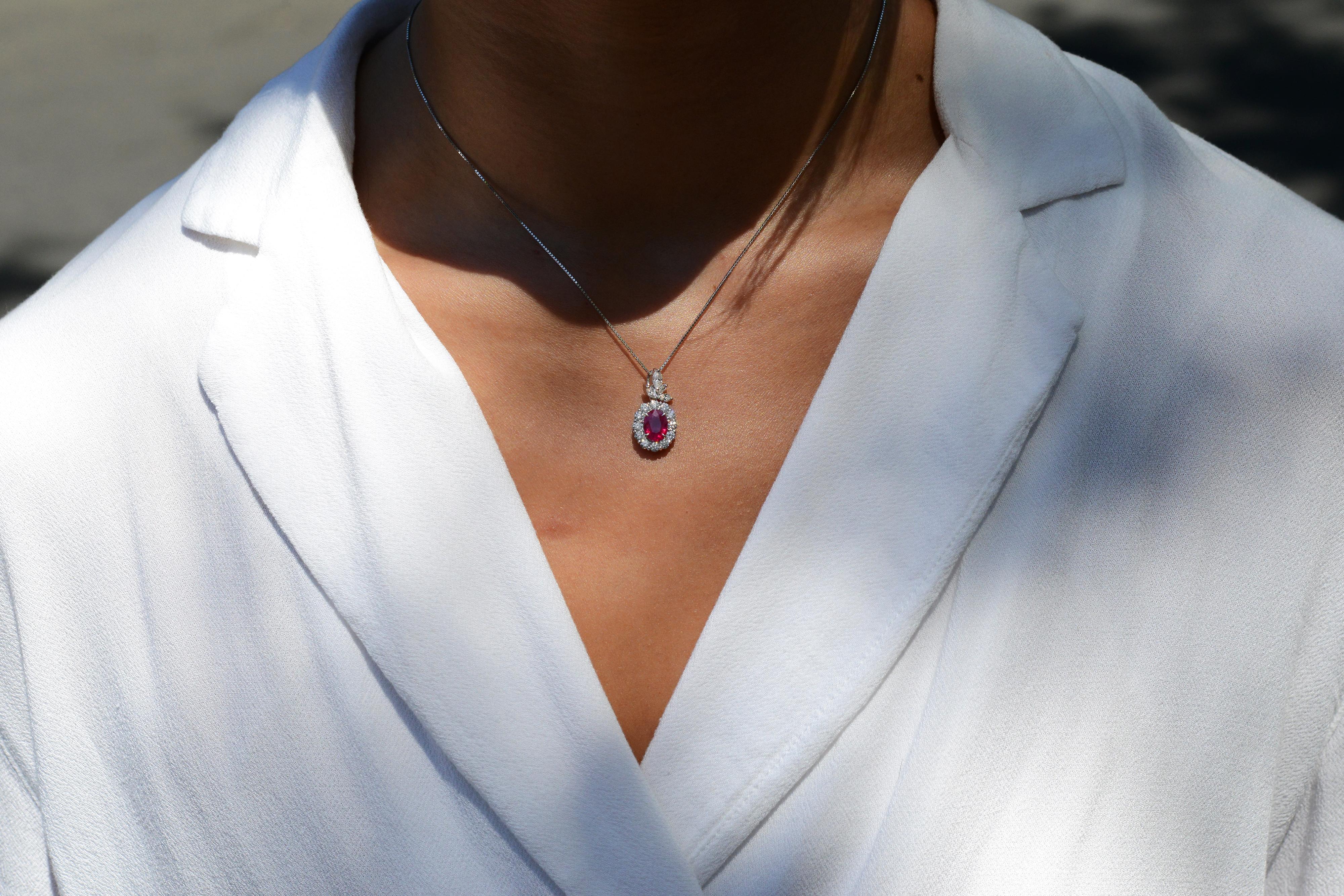 An early contemporary standout, this vintage pendant necklace will make a fabulous complement to your estate jewelry collection. The luxurious setting centers on a rare, GIA certified Burmese Pigeon Blood Red Ruby, accented by 1 carat of sparkling