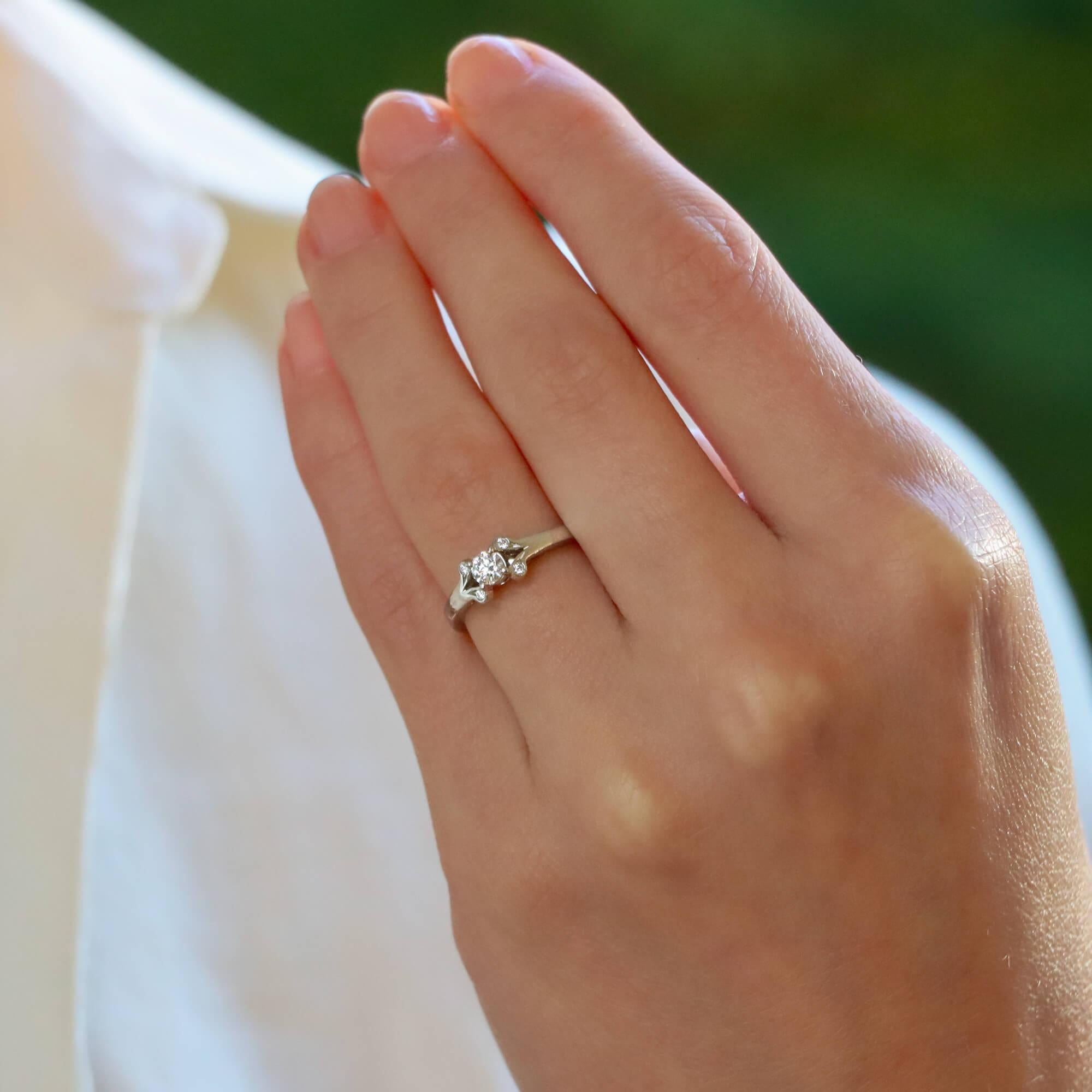 A beautiful vintage Cartier 'Ballerine' diamond ring set in platinum. 

The piece prominently features a beautiful 0.18 carat round brilliant diamond. The diamond is four claw set to centre and sided by tulip styled shoulders which are set with two