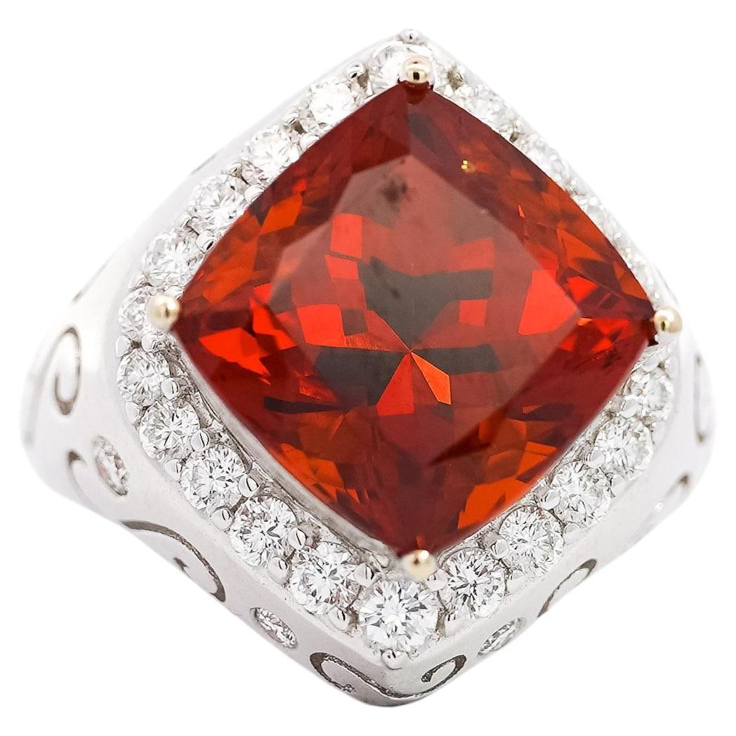 VIntage Spessartine Garnet and Diamond Ring. 

This vintage ring features a GIA-certified, vivid cushion-cut spessartine garnet center stone with a carat weight of 12.51. It is paired with 32 round-cut white diamonds totaling 1.11 carats. Crafted in