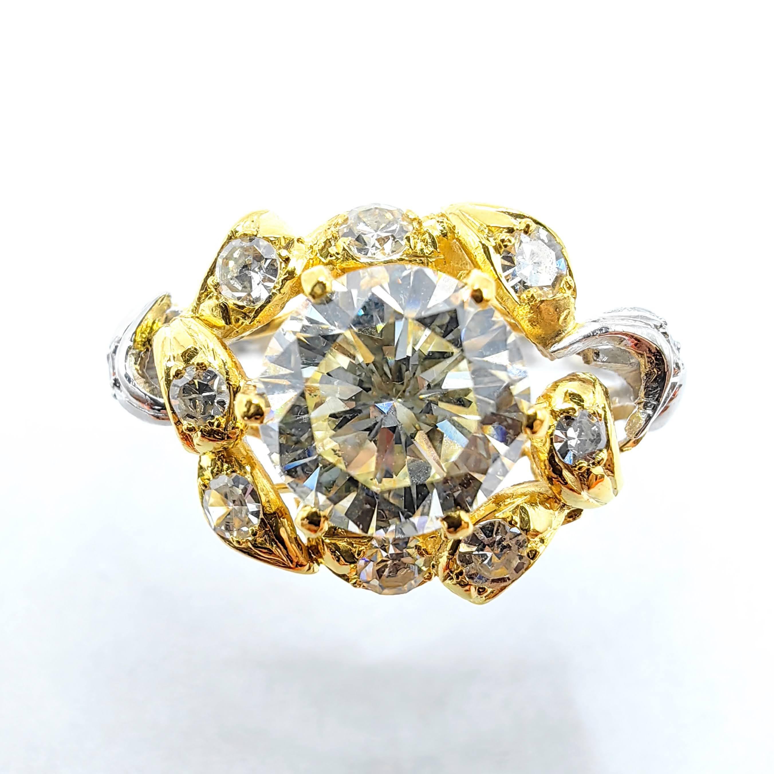 Experience the exquisite elegance of the Round Cut Diamond Floral Motif Ring in 18k Yellow and White Gold, a stunning masterpiece inspired by nature's beauty. The centerpiece of this breathtaking ring is a brilliant GIA-certified 1.21-carat