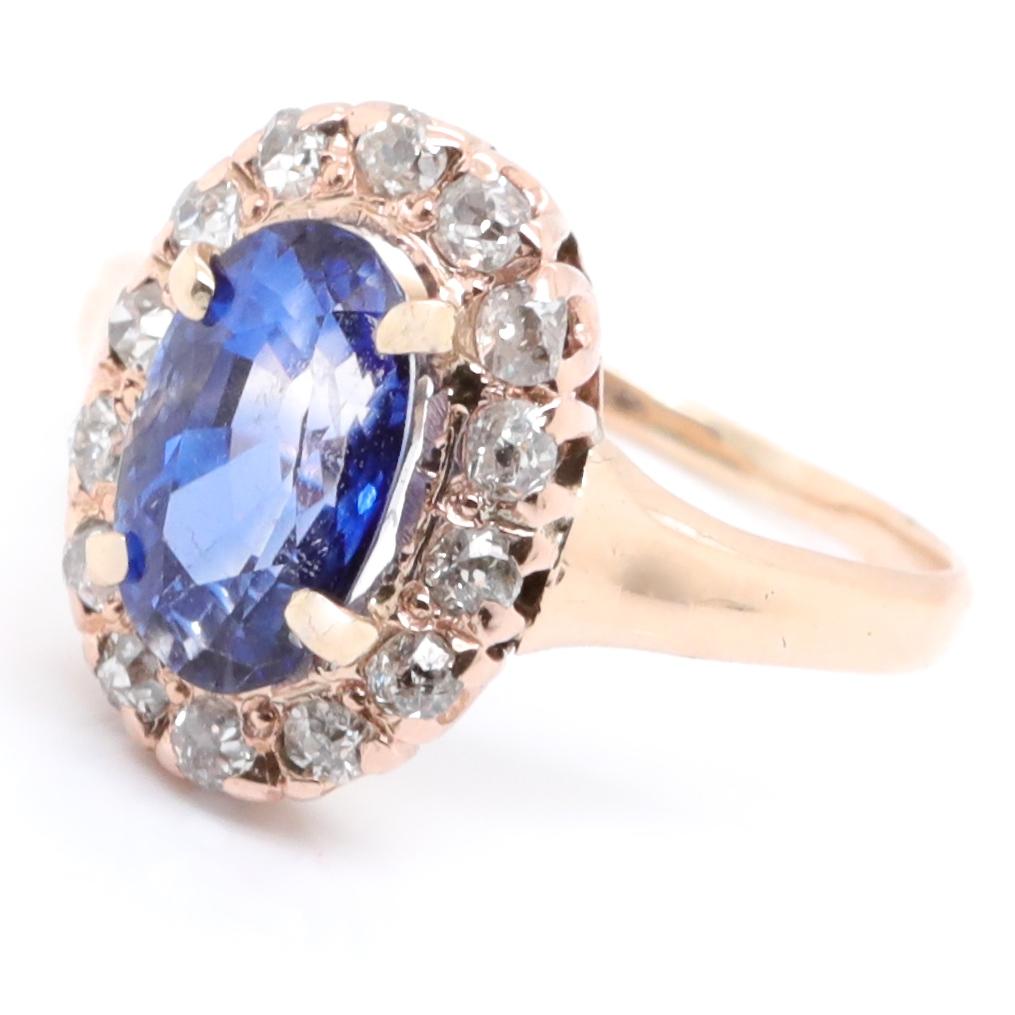 The vivid blue color of the oval sapphire goes perfectly with the sunny gold shade of the ring. Own a piece of history and luxury. The sapphire is GIA certified as Ceylon, heated (#2215358643). Approximate weight is 1.90 carats.  Adorned with 14