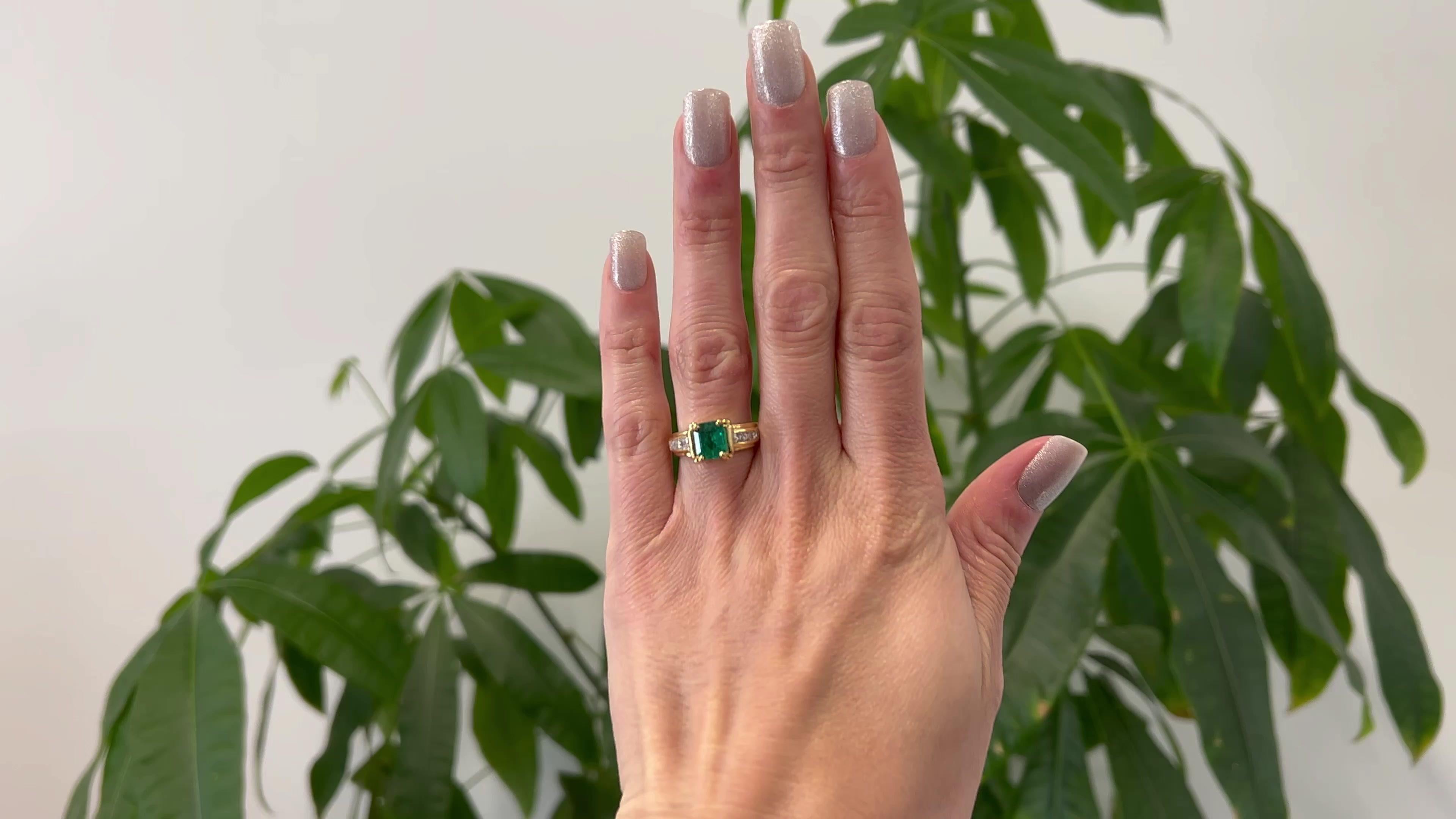 One Vintage GIA Colombian Emerald and Diamond 18k Yellow Gold Ring. Featuring one GIA octagonal step cut emerald weighing approximately 1.25 carats, accompanied with GIA #5221947032 stating the emerald is of Colombian origin. Accented by six
