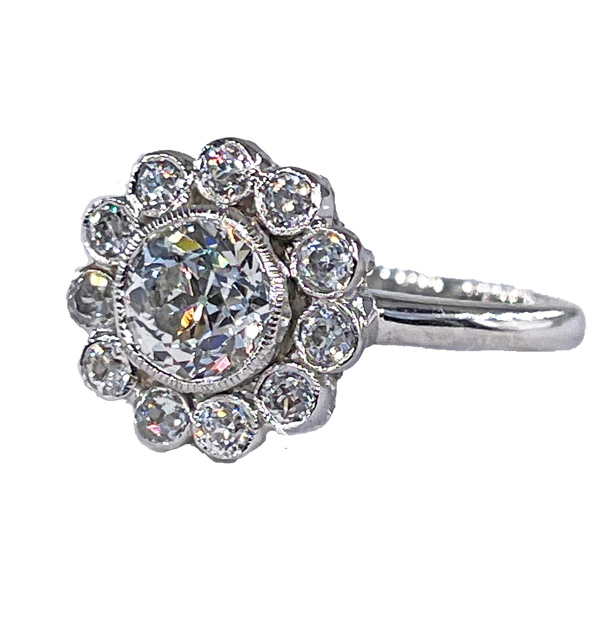 Vintage GIA Colorless 2.06ctw Old European Diamond Cocktail Flower Cluster Platinum Ring.
This breathtakingly shimmering classic Edwardian style flower-shaped cluster, composed of 12 bright-white old European-cut diamonds totaling approx. 2.05