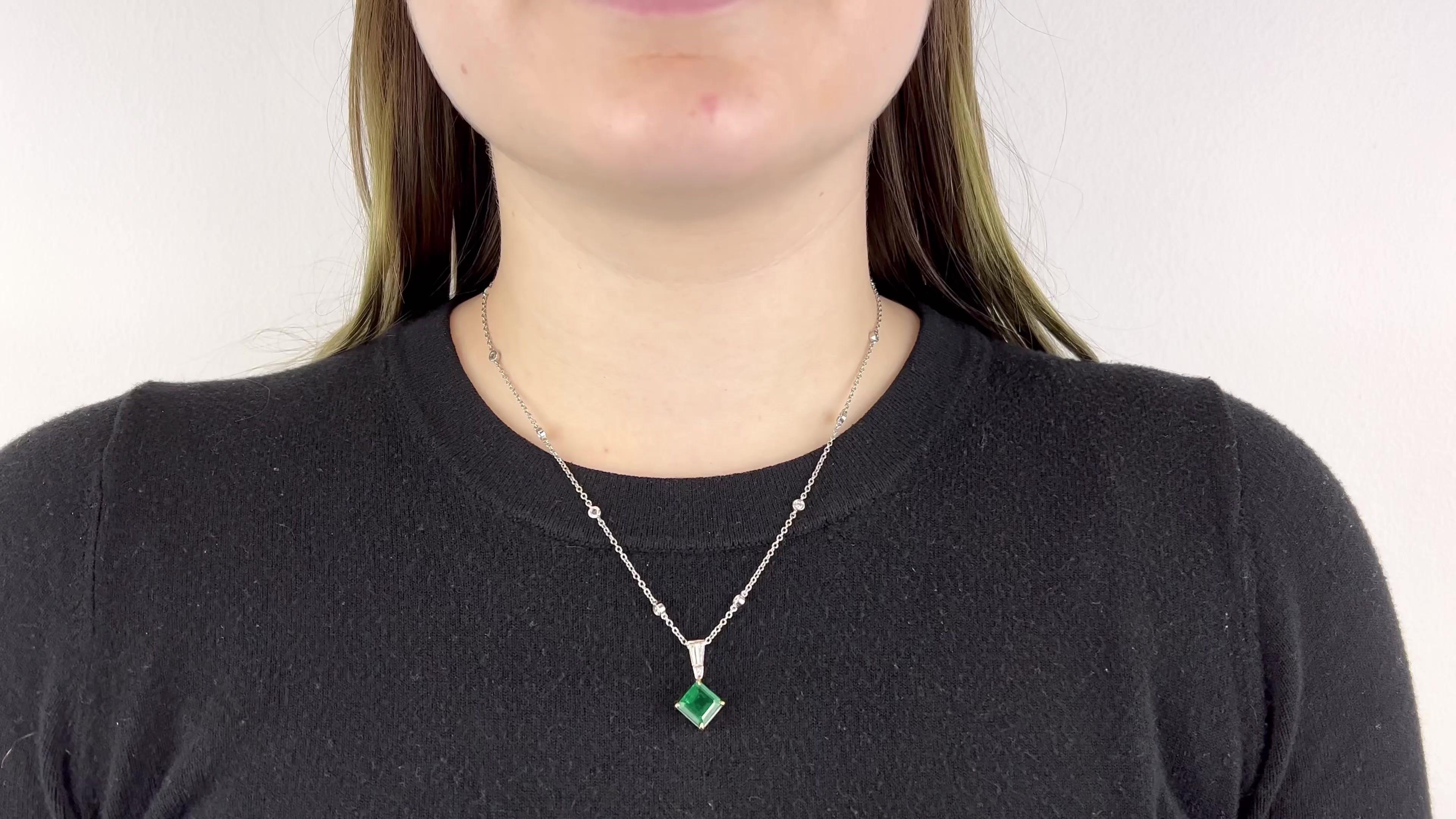 One Vintage GIA Emerald Diamond 18 Karat White Gold Pendant Necklace. Featuring one square emerald of approximately 2.40 carats, accompanied with certificate #2225307636. Accented by two tapered baguette cut diamonds with a total weight of