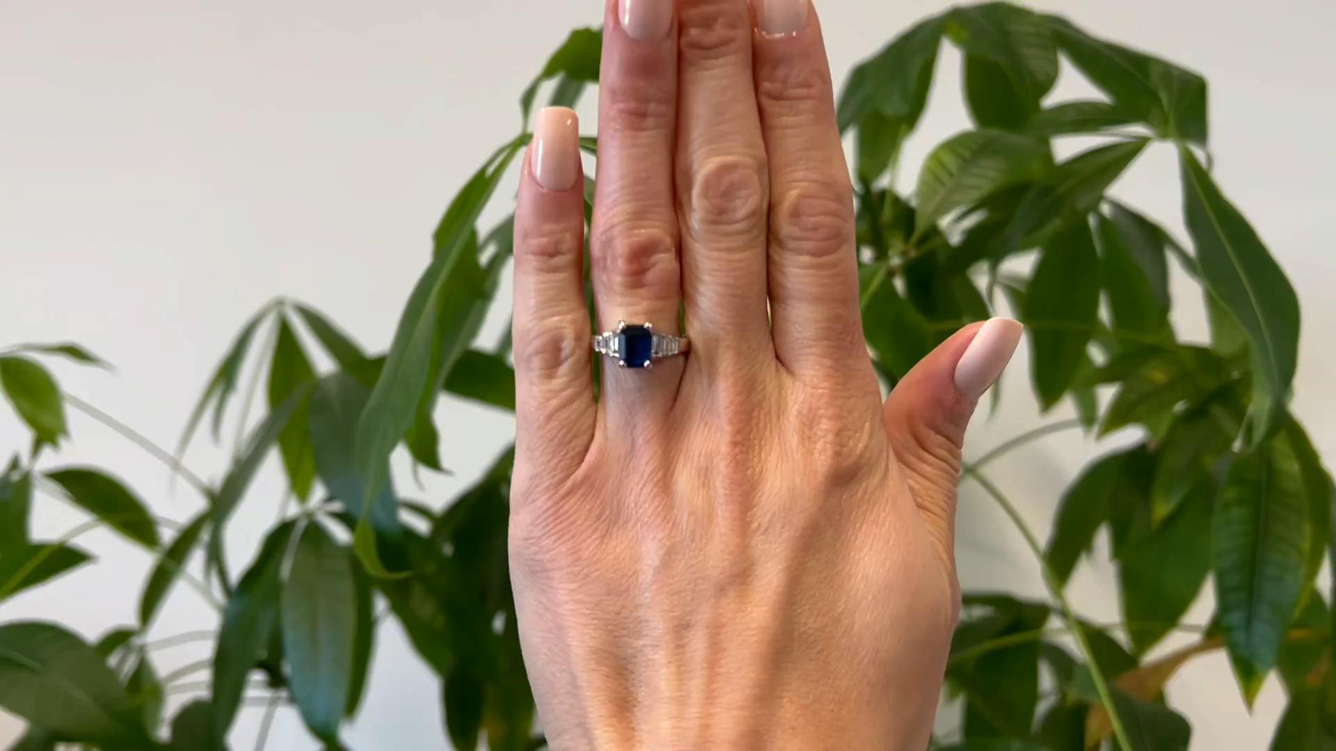 One Vintage GIA Thai Sapphire and Diamond 18k White Gold. Featuring one GIA octagonal mixed cut sapphire weighing approximately 1.75 carats, accompanied with GIA #2239102566 stating the sapphire is of Thai origin. Accented by six baguette cut