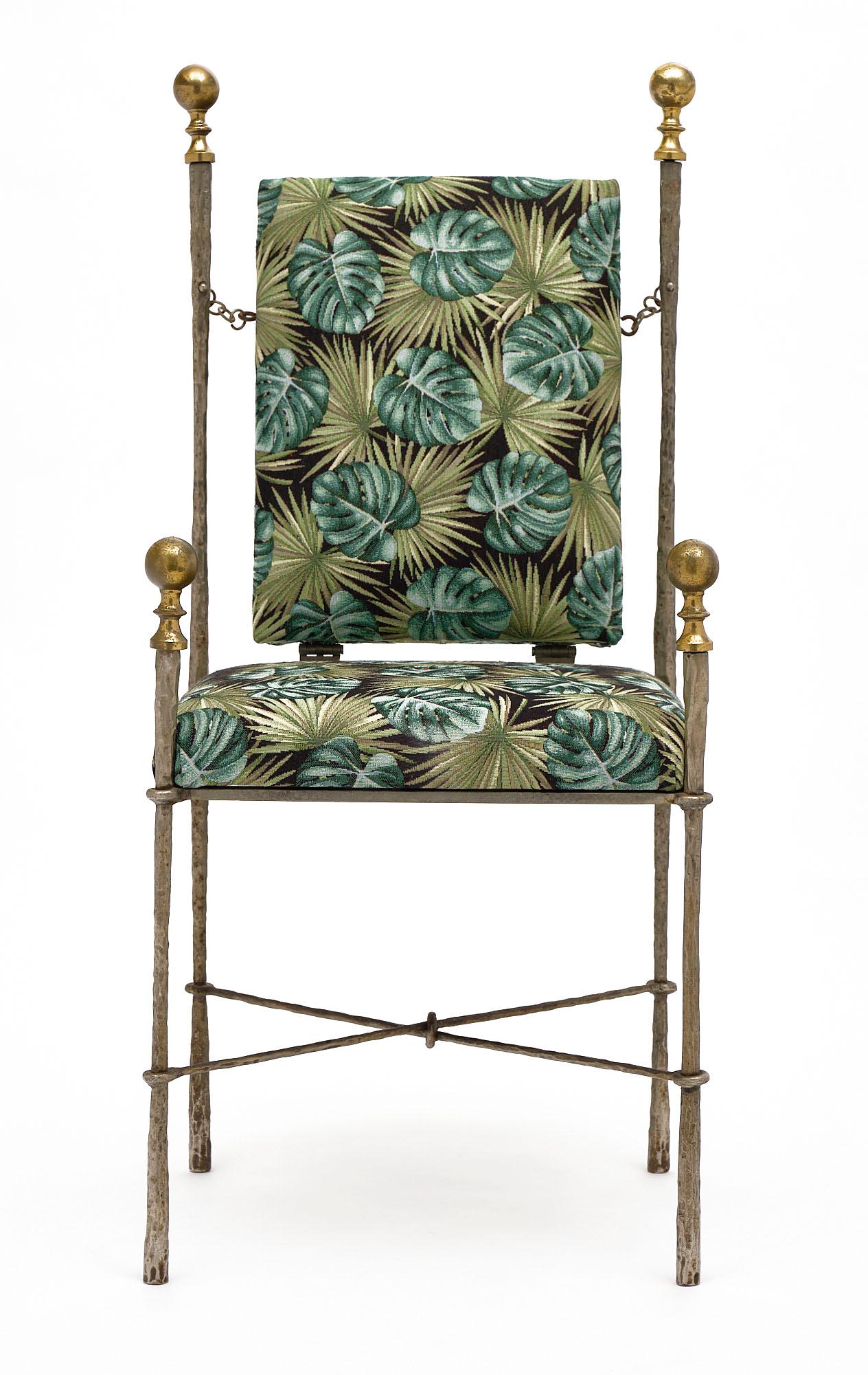 Italian armchair in the manner of Swiss sculptor Diego Giacometti. We love the hand-hammered, forged, and polished steel with bronze finials. The new upholstery is a palm leaf wool blend. This piece is in excellent vintage condition.
