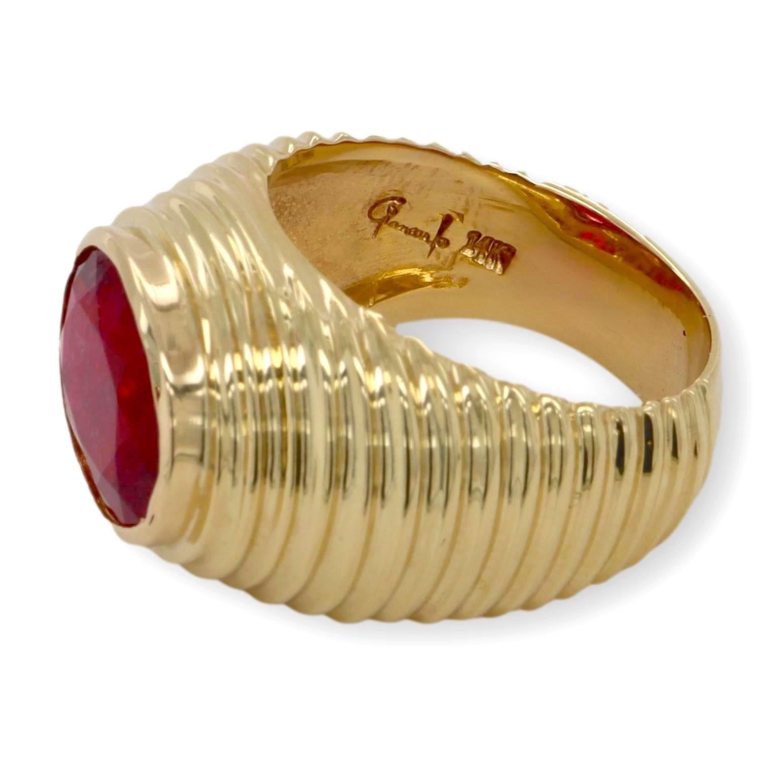 Vintage ring signed by Giancarlo finely crafted in 14 karat yellow gold featuring an oval tourmaline center weighing 3.50 carats approximately in a rich deep pink color set in a bezel design with a ridge design shank. 13mm wide at from to 7mm wide