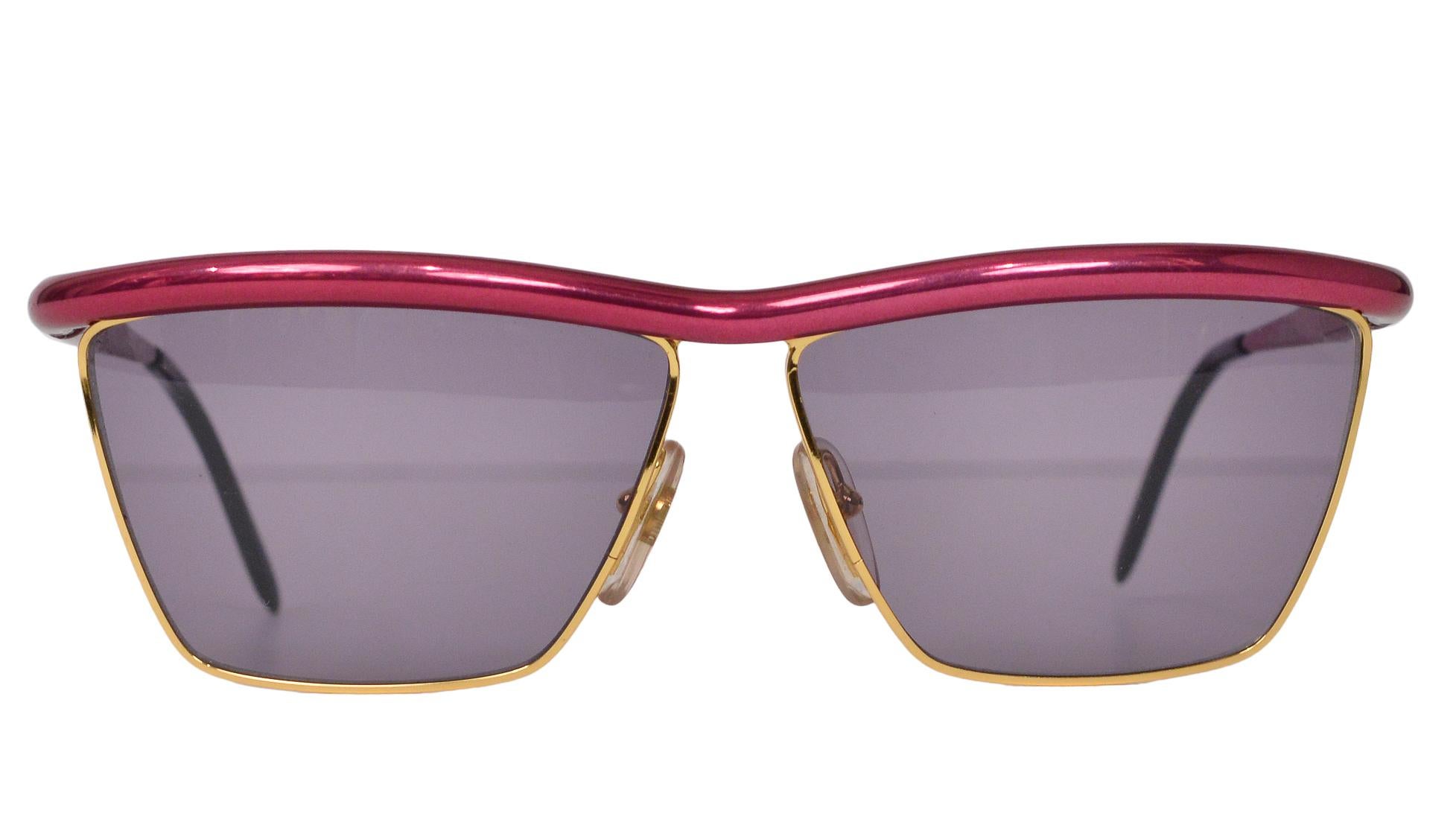 Resurrection Vintage is excited to offer a pair of vintage Gianfranco Ferré square gold-tone metal sunglasses featuring a metallic pink brow bar and smoky lenses. 

Gianfranco Ferré
Made in Italy
Excellent Vintage Condition 
Authenticity Guaranteed 
