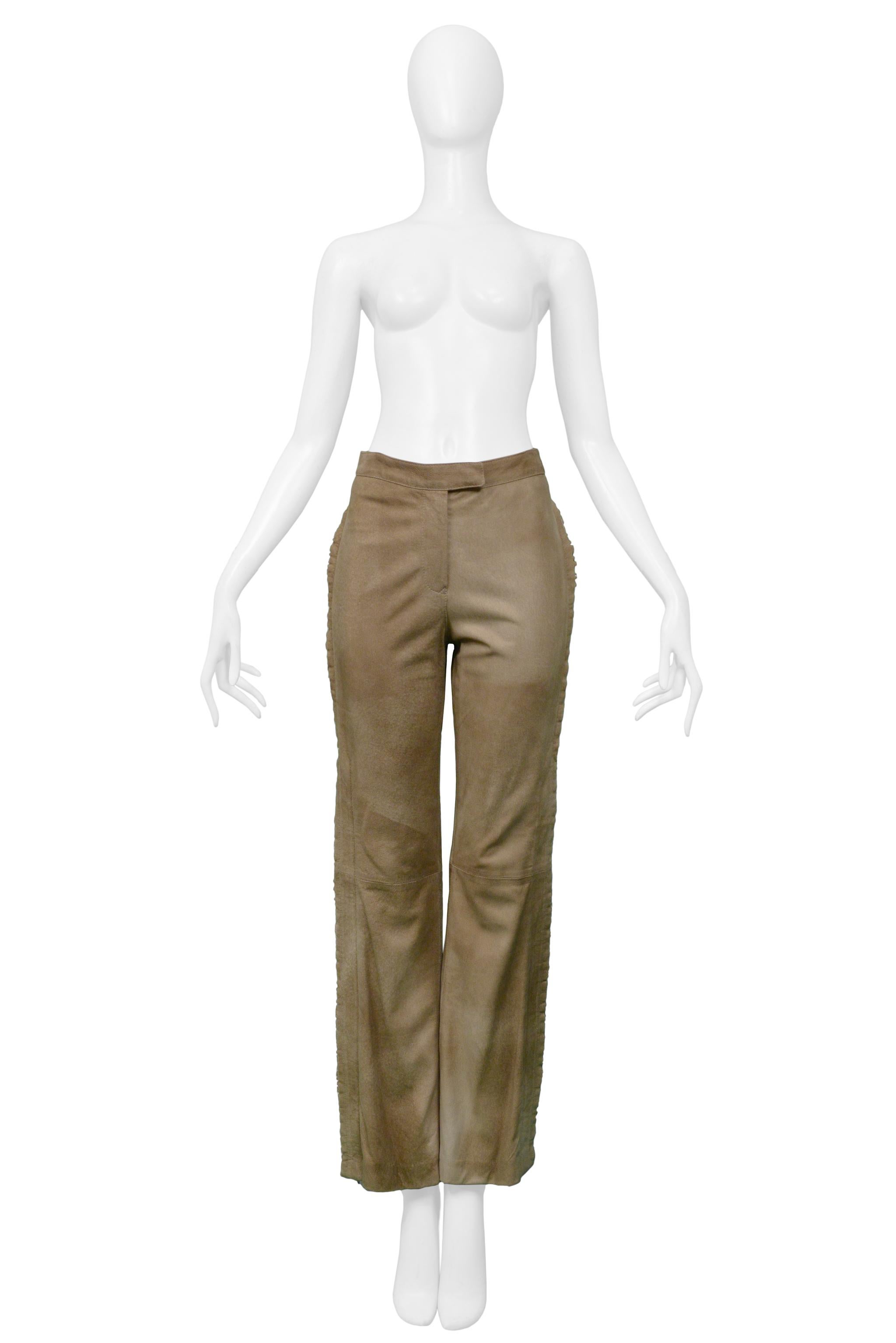 Resurrection Vintage is excited to offer a vintage pair of Gianfranco Ferre tan suede pants featuring a flat front, covered center front zipper and hook closure, ruffled trim at sides, and back buckle detail.

Gianfranco Ferre
Small
Suede
Excellent