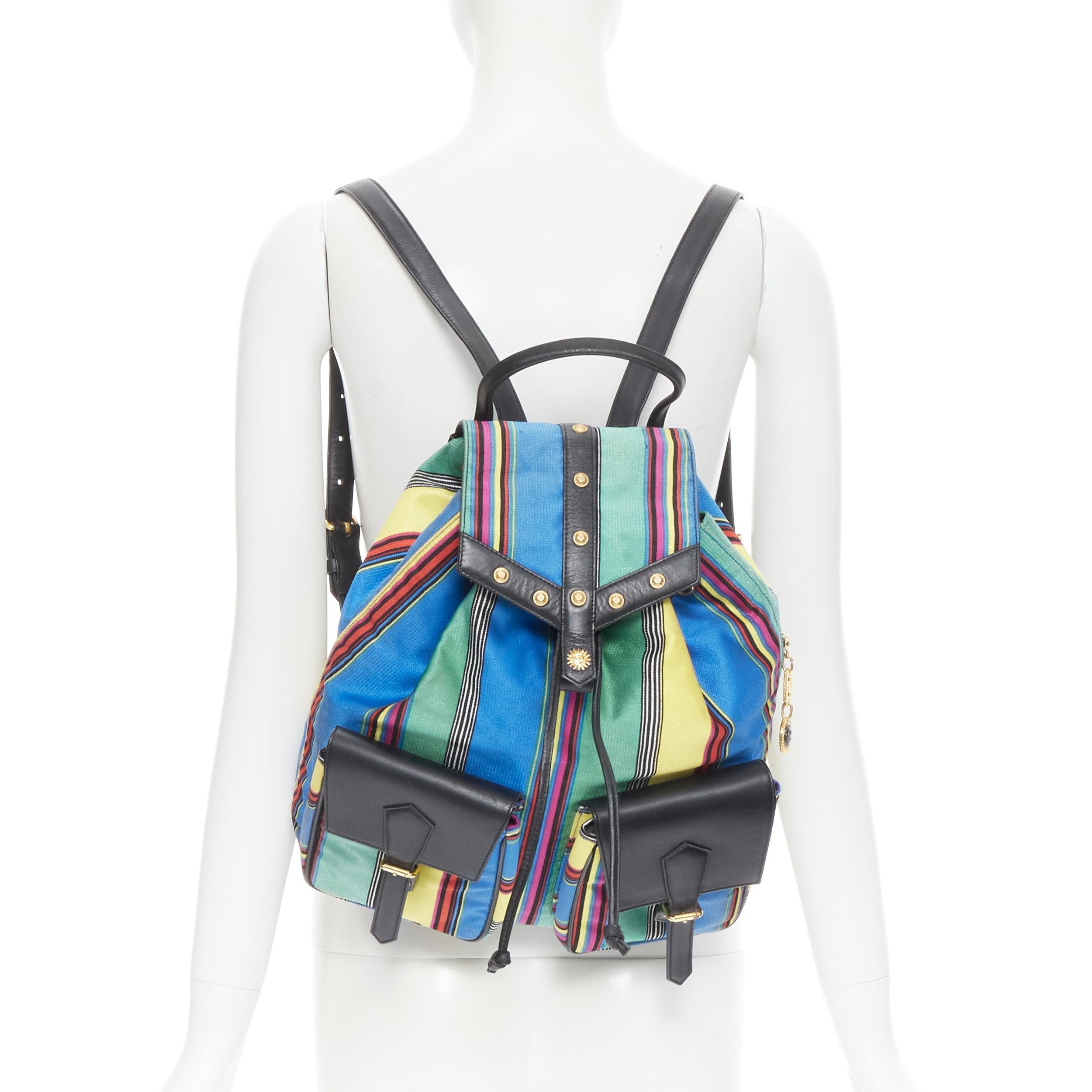 vintage GIANNI VERSACE 1990's striped canvas gold studded flap backpack bag 
Reference: TGAS/B01107 
Brand: Gianni Versace 
Designer: Gianni Versace 
Model: Canvas striped backpack
Material: Fabric 
Color: Blue 
Pattern: Striped 
Closure: Magnetic