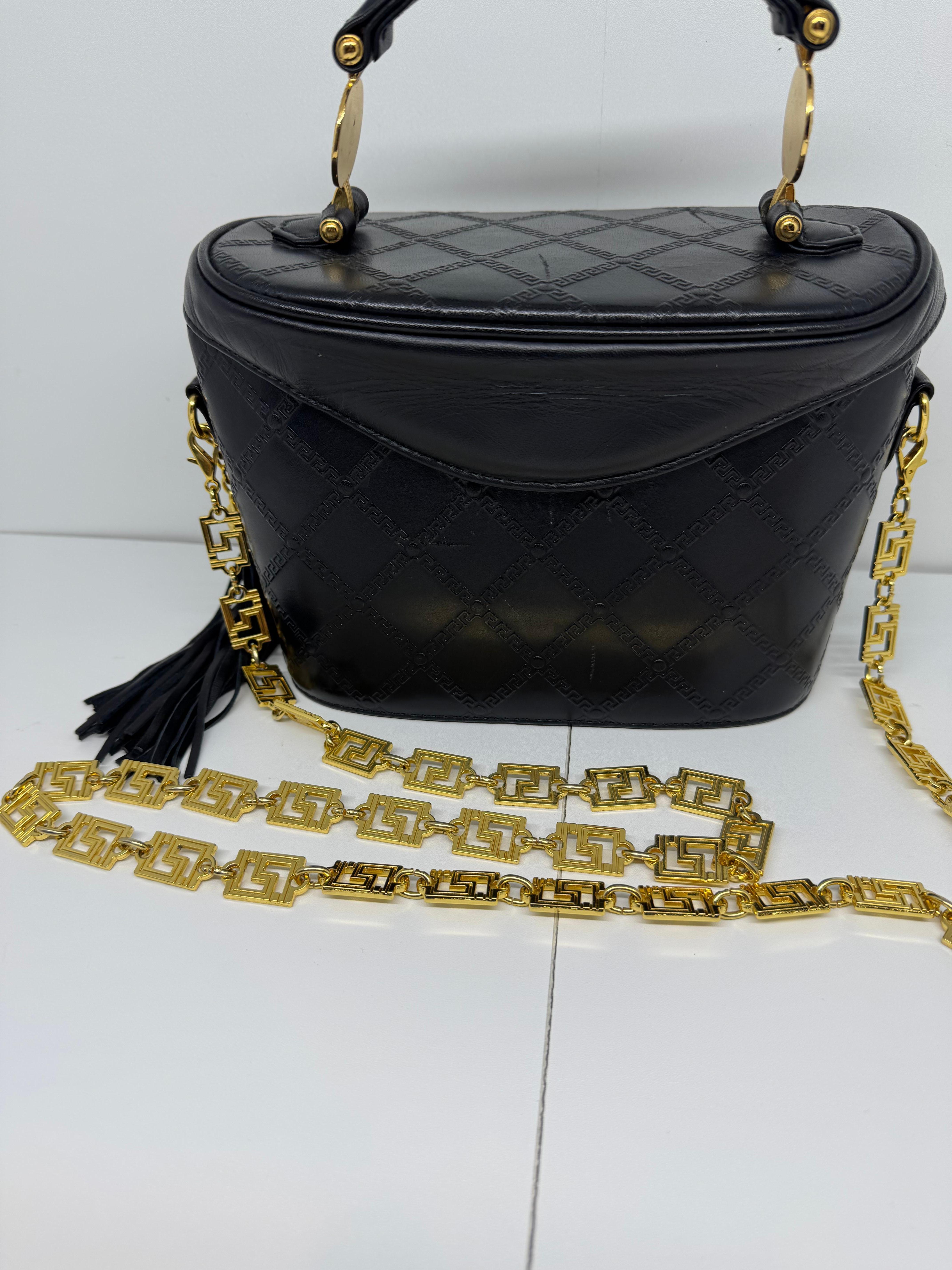 Vintage magnetic flap Gianni Versace Vanity Bag. Comes as is. Visible creasing on the leather flap top. There are noticeable scratch marks on the leather surface as seen on the pictures. Comes with a intricate designed chain. Clean interior. Strong
