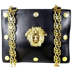 Vintage Gianni Versace black leather tote bag with big golden medusa motif. Rare