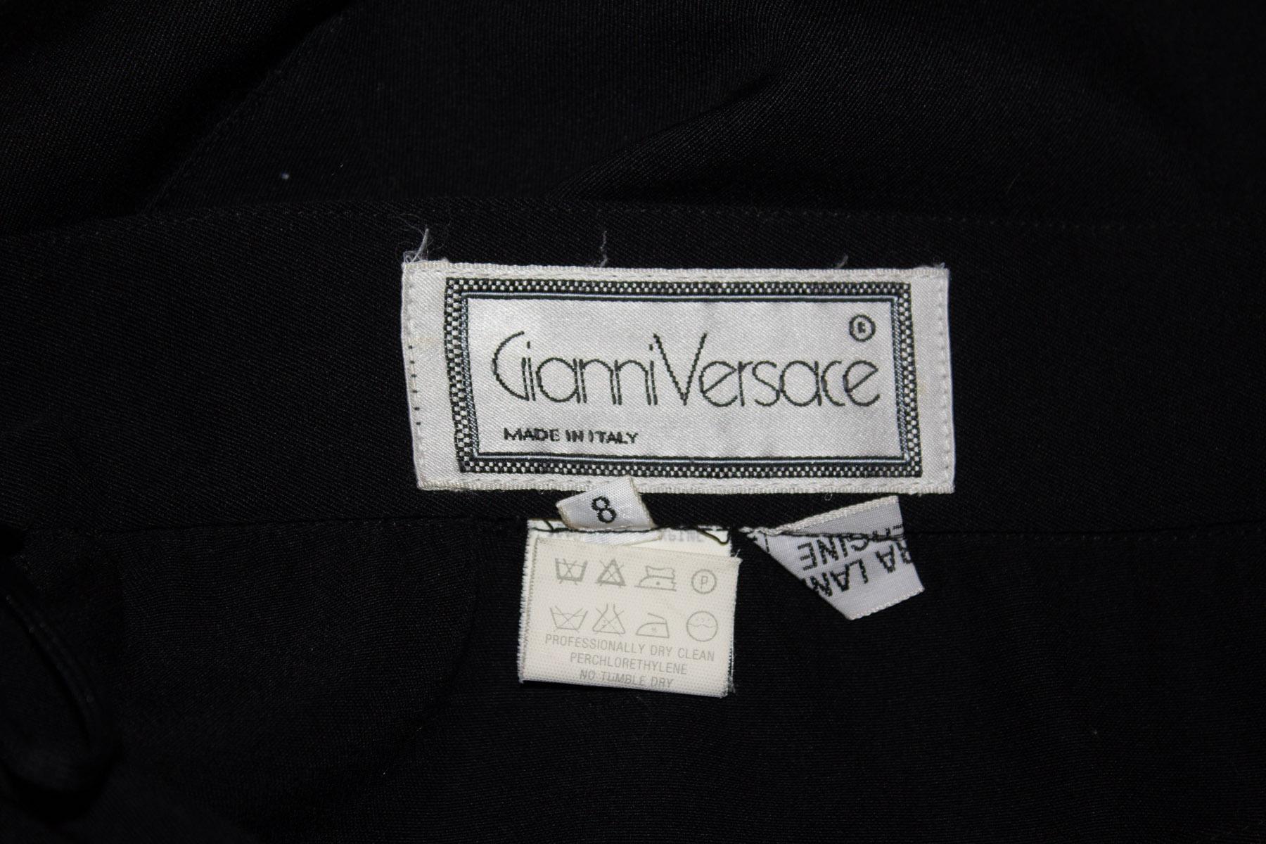 A great vintage black wool skirt by Gianni Versace. The skirt has a four button front opening with pleat detail at the front and back . It is unlined. 
Size Italian 42 / 8 . measurements: waist 27'', length 34''