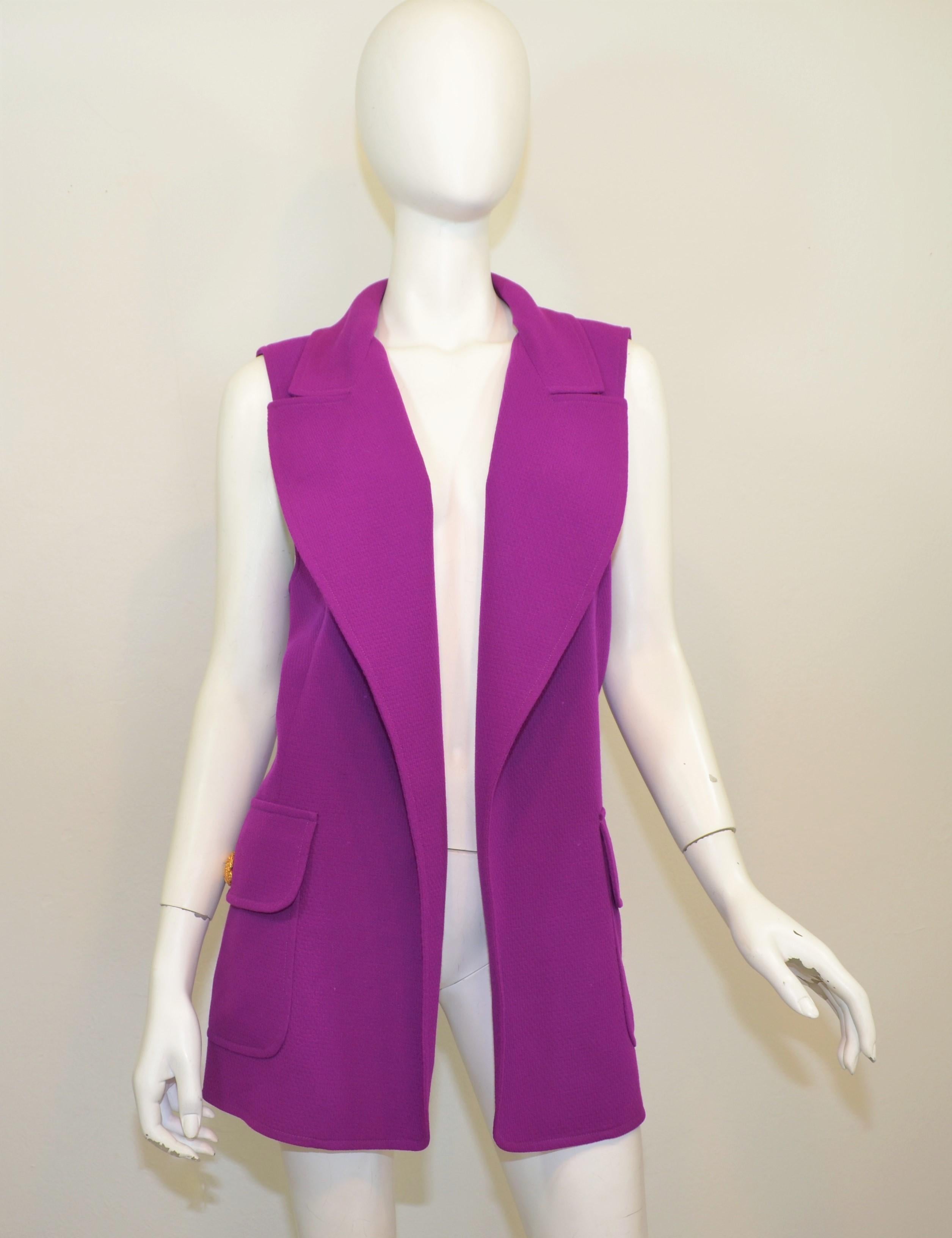 Vintage Gianni Versace Couture Vest featured in a bright purple composed with a wool-like fabric (there is not a contents label attached) and functional flap pockets with gold-tone button closures. Vest is in wonderful vintage condition with a small