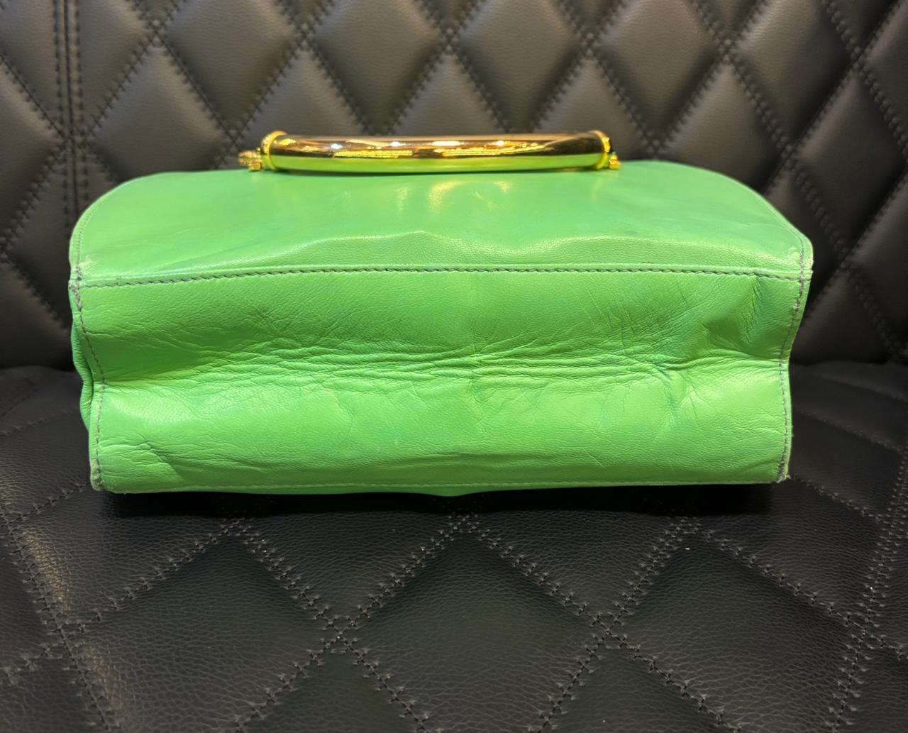 Vintage Gianni Versace Round tote in green leather with gold metal medusa handles. Slight creasing on the leather and corners. Wrinkling and rubbing on the corners. Slight dents throughout. Comes as is.