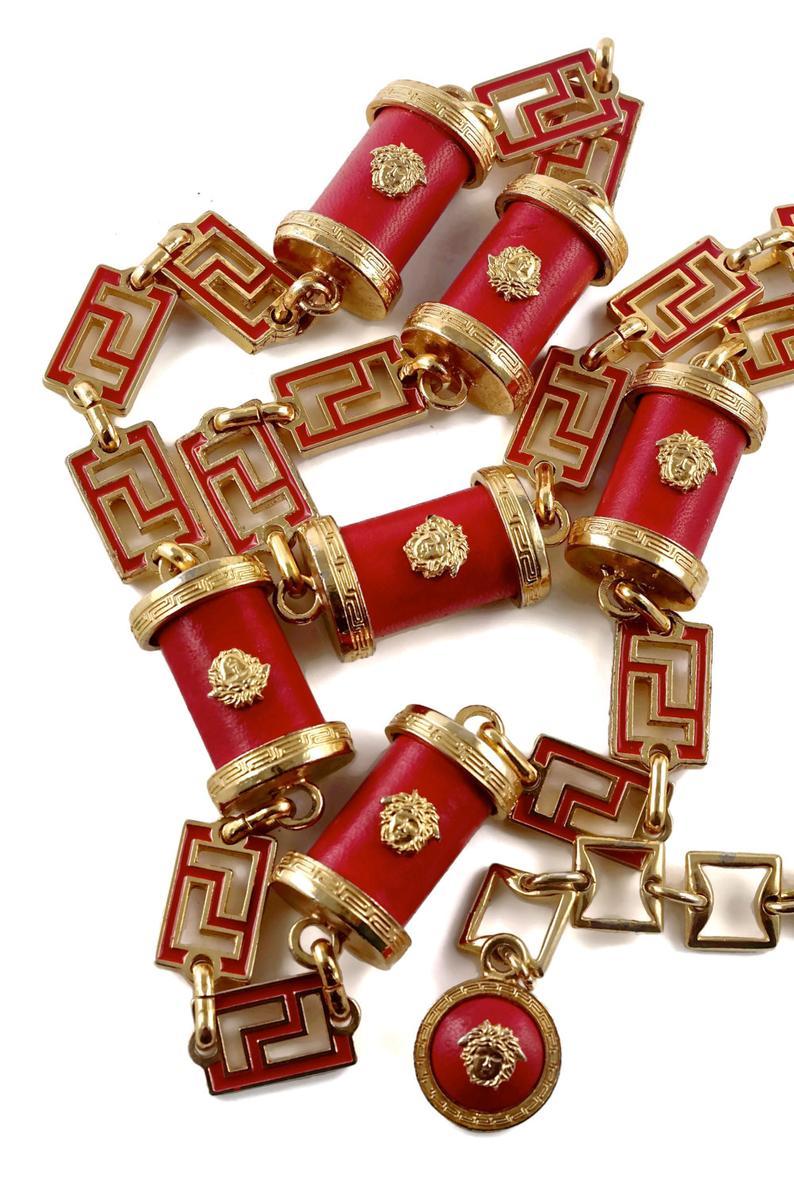 Vintage GIANNI VERSACE Iconic Medusa Red Leather Enamel Chain Medallion Necklace Belt

Measurements:
Height: 1 inch (2.54 cm)
Length: 50 4/8 inches (128.27 cm)
ONE SIZE FITS MOST DUE TO ITS ADJUSTABLE FEATURE.

Features:
- 100% Authentic GIANNI