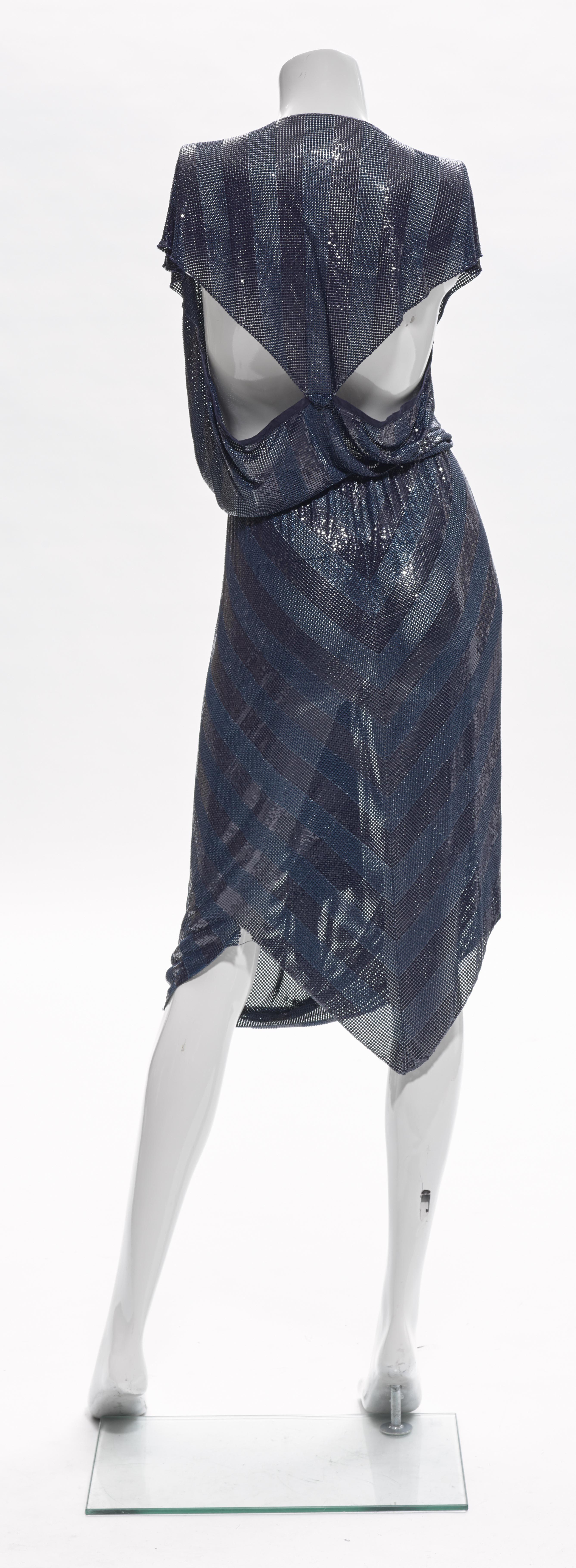 Ca. 1983 Gianni Versace striped navy Oroton metal mesh chainmail dress featuring a deep V-neckline, cutouts at the back bodice, a gathered waistline and multiple folds at center front of the skirt. There is a 1.5