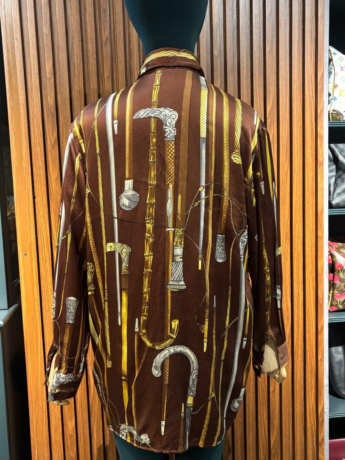 Gianni Versace vintage printed silk shirt in dark brown. Size label has been removed. But fits like men L size. Length from top to bottom is 81.5 cm and the bust length is 54 cm. Minor fabric pull on some areas.