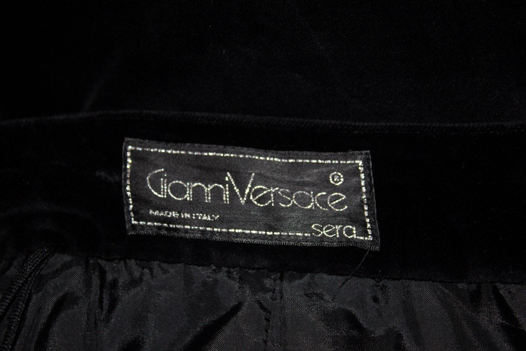 A fun vintage black velvet skirt by Gianni Versace. The skirt has a zip and button opening .and is in three tiers - so moves beautifully. It is mostly lined.  
Size EU Italian 42 Measurements waist 28'', length 28''