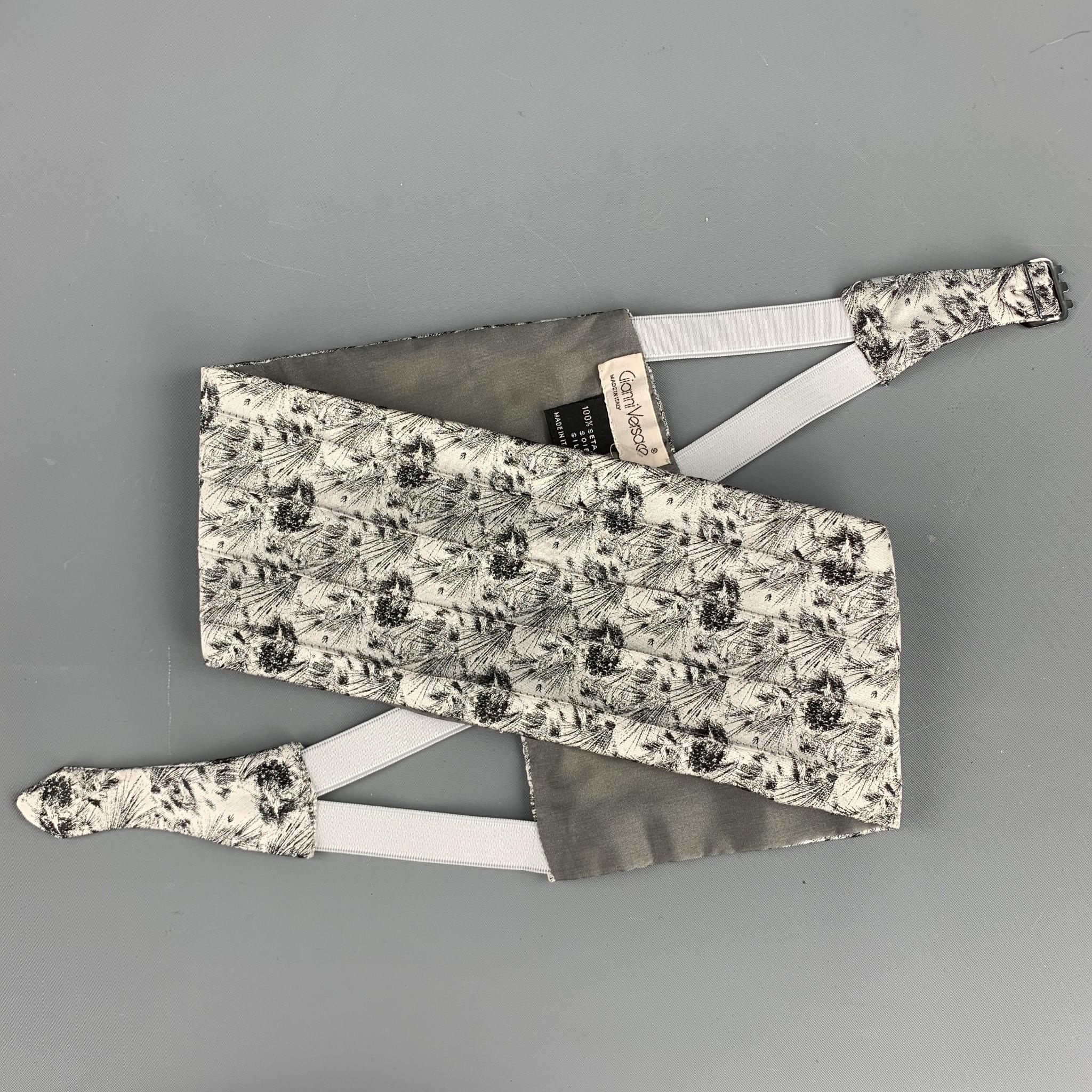 Vintage GIANNI VERSACE cummerbund comes in a silver & black jacquard silk featuring a buckle closure and includes a matching bow tie. Made in Italy.

Excellent Pre-Owned Condition.

Measurements:

Width: 4 in.
Length: 37 in.  