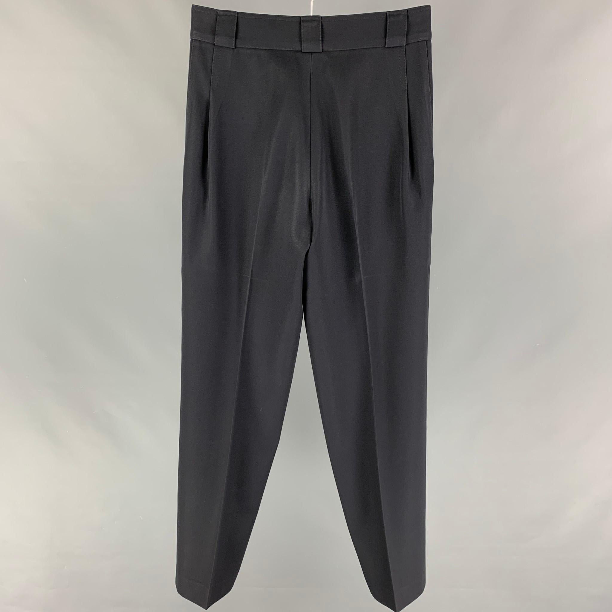 Vintage GIANNI VERSACE dress pants comes in a black wool featuring a pleated front style, high waisted, and a zip fly closure. Made in Italy. 

Very Good Pre-Owned Condition.
Marked: 44

Measurements:

Waist: 30 in.
Rise: 12 in.
Inseam: 32 in. 