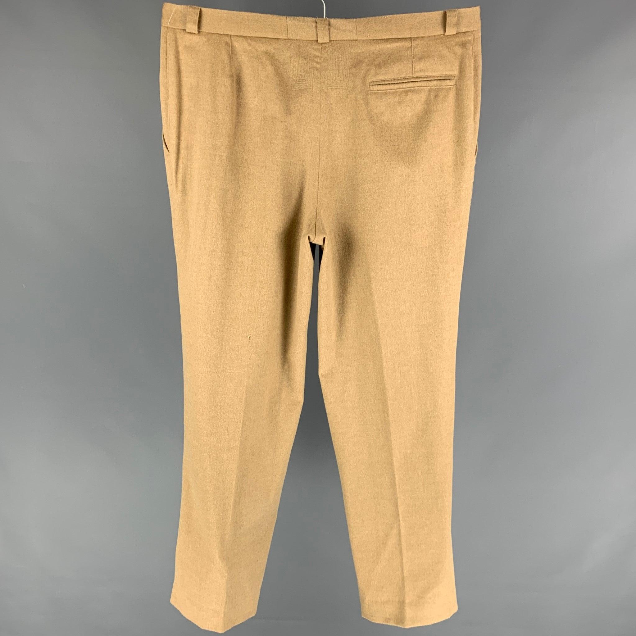 Vintage GIANNI VERSACE dress pants comes in a tan angora wool featuring a pleated style, loose fit, and a zip fly closure.
Good
Pre-Owned Condition. 

Marked:   50 

Measurements: 
  Waist: 38 inches  Rise: 12.5 inches  Inseam: 32 inches 
  
  
