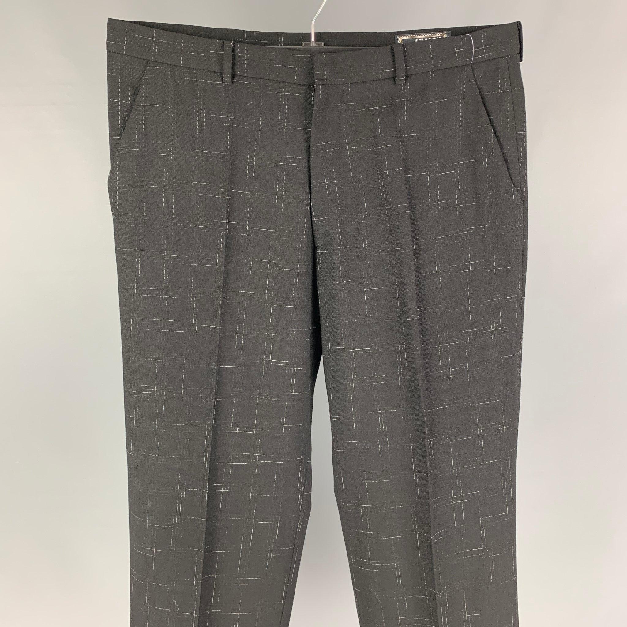Vintage GIANNI VERSACE dress pants comes in a black print wool featuring a flat front, cuffed leg, front tab, and a zip fly closure. Made in Italy.
Very Good
Pre-Owned Condition. 

Marked:   52 

Measurements: 
  Waist: 36 inches  Rise: 11.5 inches 