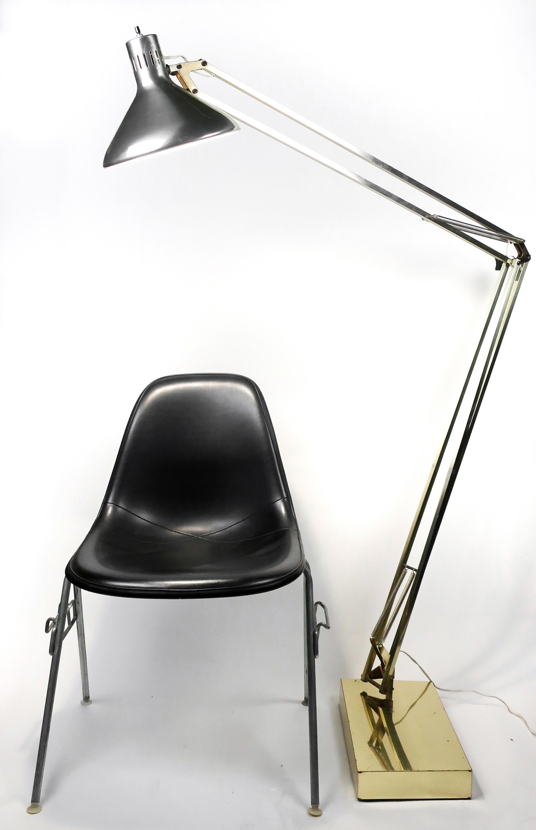 A Mid-Century Modern vintage brass floor drafting/architect's lamp in the style of Luxo. Brass-plated articulating arm with heavy base. So large that it works over a couch, a dining room table, or as a giant bedside lamp.

Works great and is in