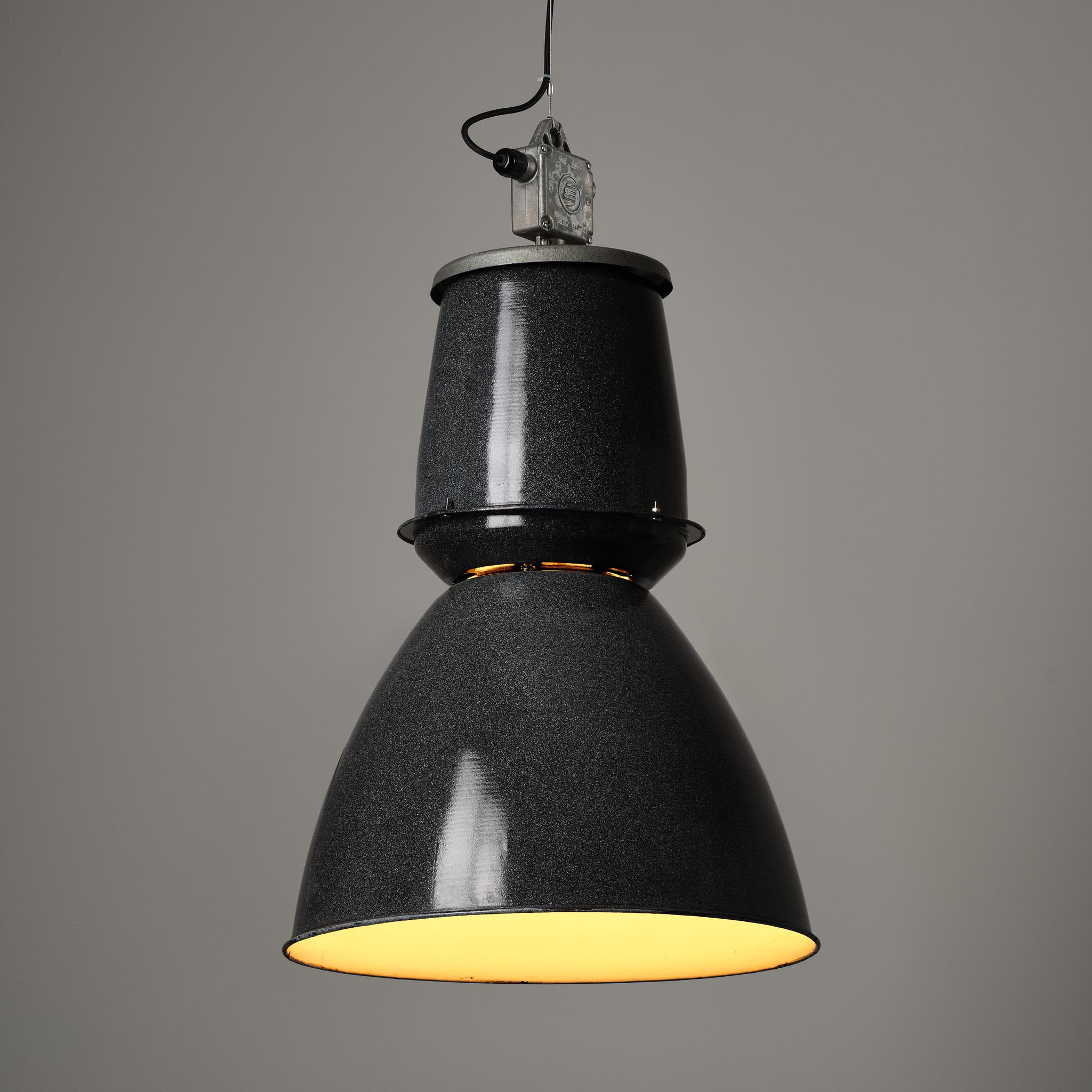 Substantial vintage industrial pendant lights reclaimed from communist-era factories in the Czech Republic. An Eastern Bloc design classic.

Original black/grey enamel. Cleaned and re-wired to the usual Trainspotters standards but otherwise