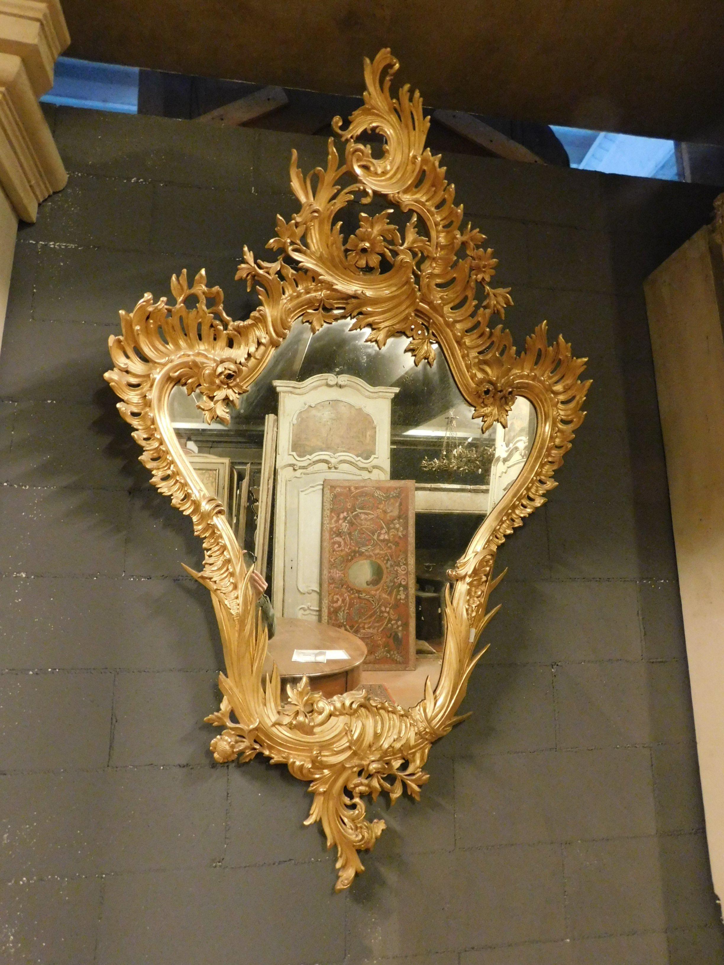 Vintage, antique wooden mirror, with original gilded leaf frame, rich hand carved frame with many swirls and frills, from the Art Nouveau period, early 1900s, produced in Italy.
Ideal as an enrichment of a trendy and luxurious home, impressive,
