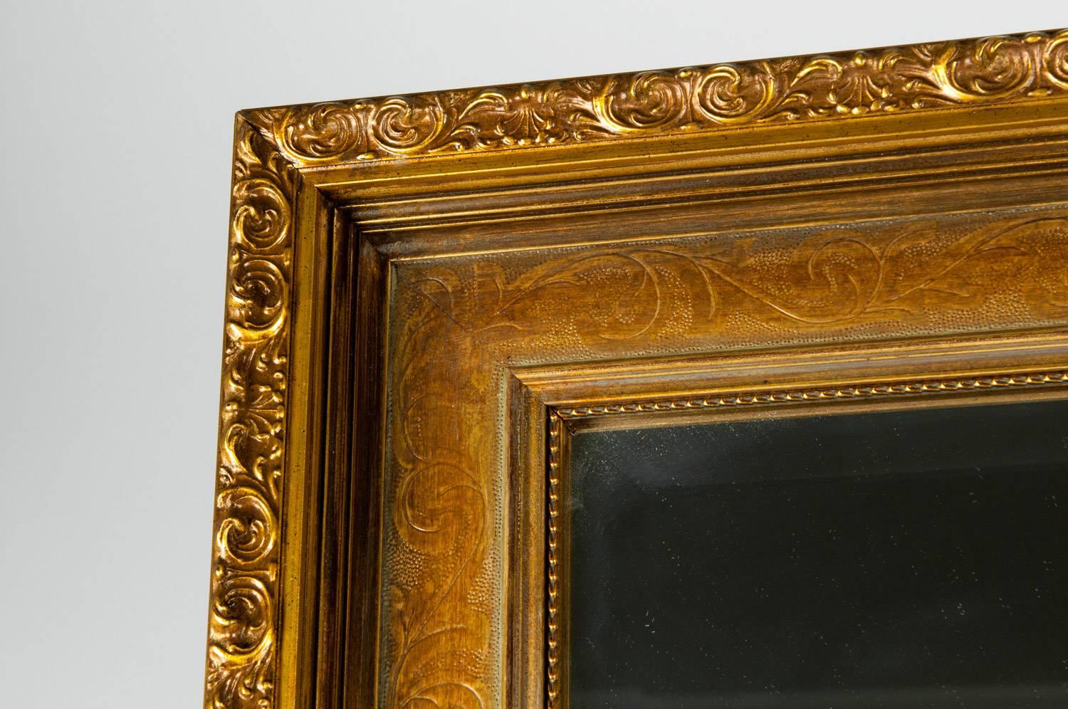 Vintage gilded wood framed hanging wall mantel / fireplace decorative bevelled mirror. The mirror measure about 58 inches long x 38 inches width x 2 inches deep.