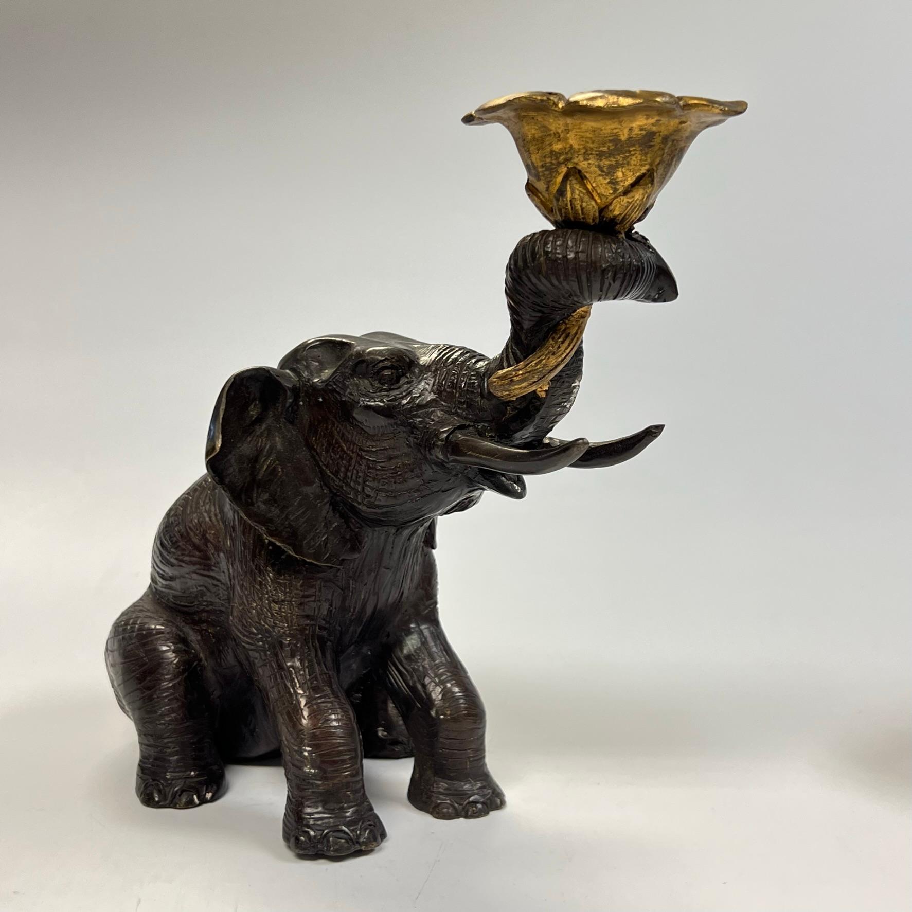 Pair of patinated and gilt candle holders in the form of seated Indian elephants.  Apparently unsigned.