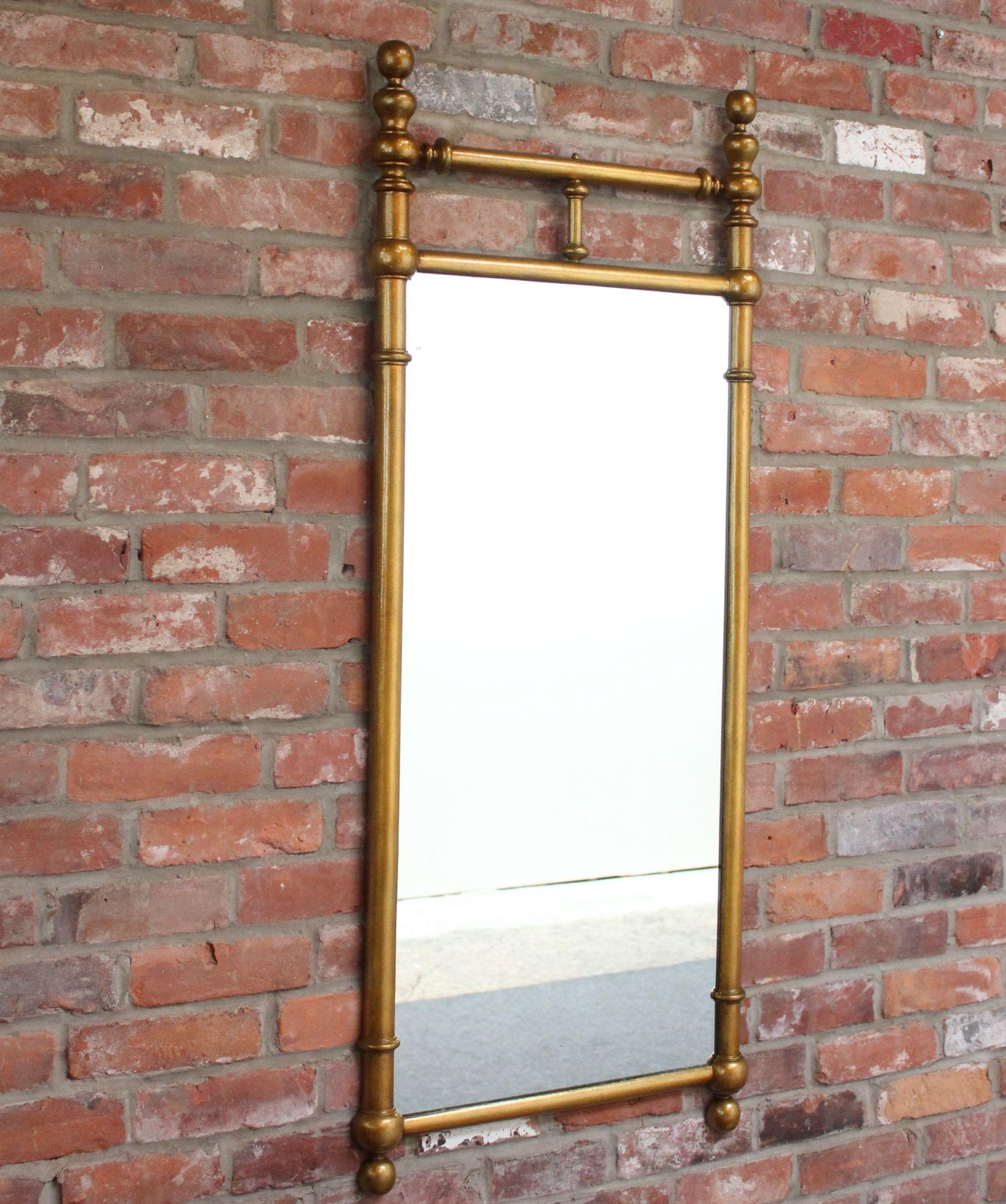 Ornate decorative wall mirror with cast gilt-metal frame.
Elegant, unique piece with rich patina to the gilt and a couple of glass scratches present along with light surface scuffing. Does not affect the clarity of the glass (maintains a clear