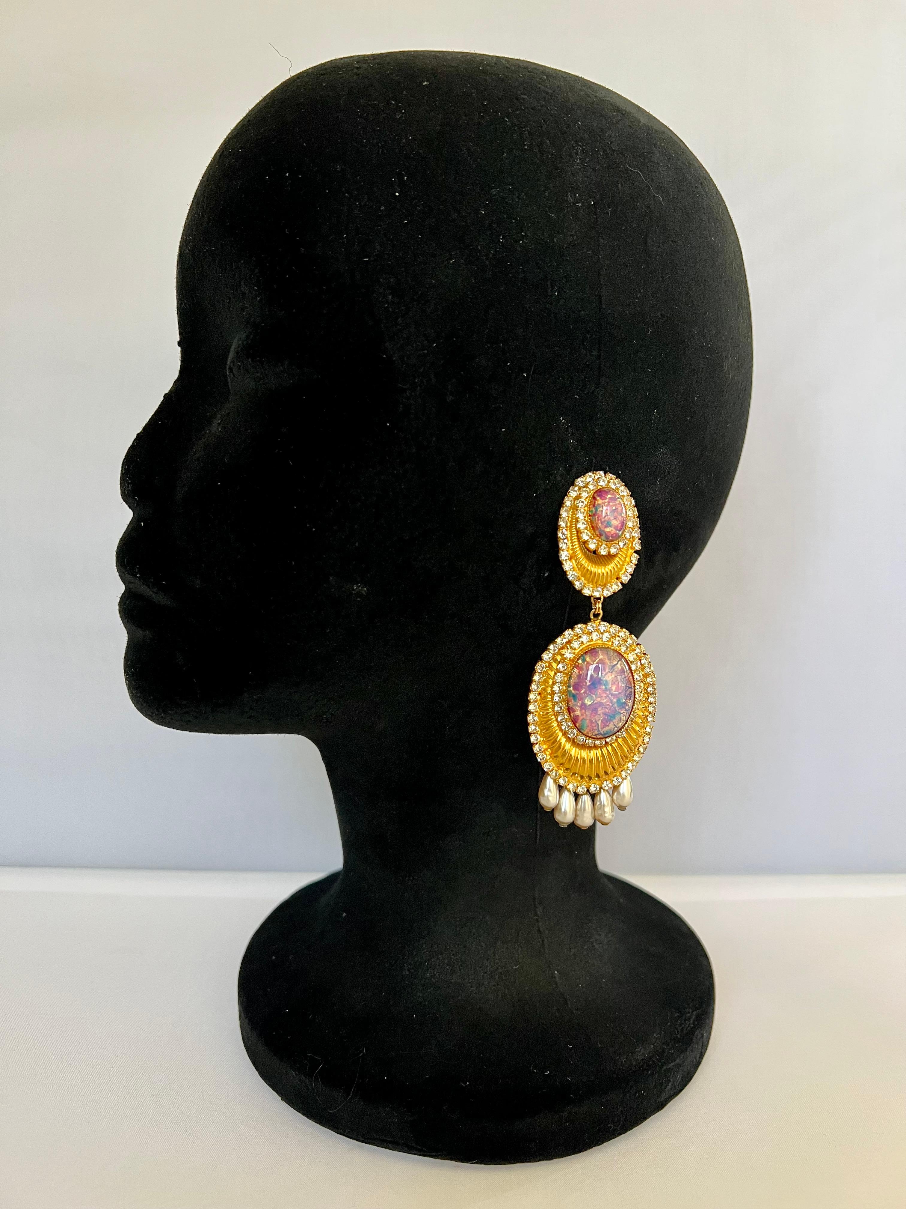 Vintage scarce clip-on statement earrings, comprised out of textured gilt metal (14k gold electroplated), adorned by diamante rhinestones, faux glass opals, and faux French glass pearls. Signed William de Lillo, made in 1969.