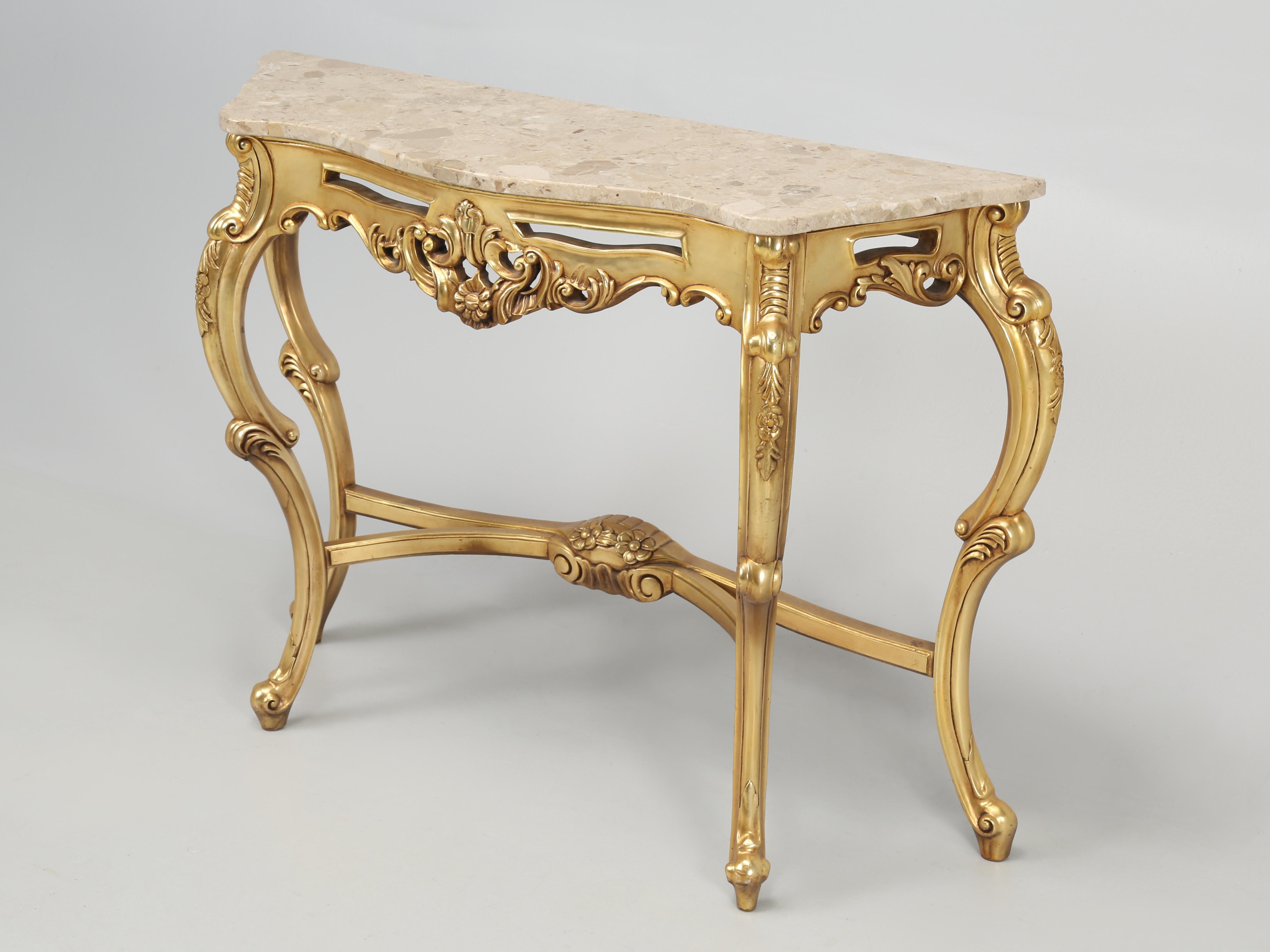 French style Rococo gilt console table with a marble top. Because this French inspired gilt console table came from another dealers stock, unfortunately we have no accurate history. Our hypothesis says that the French console table was produced off