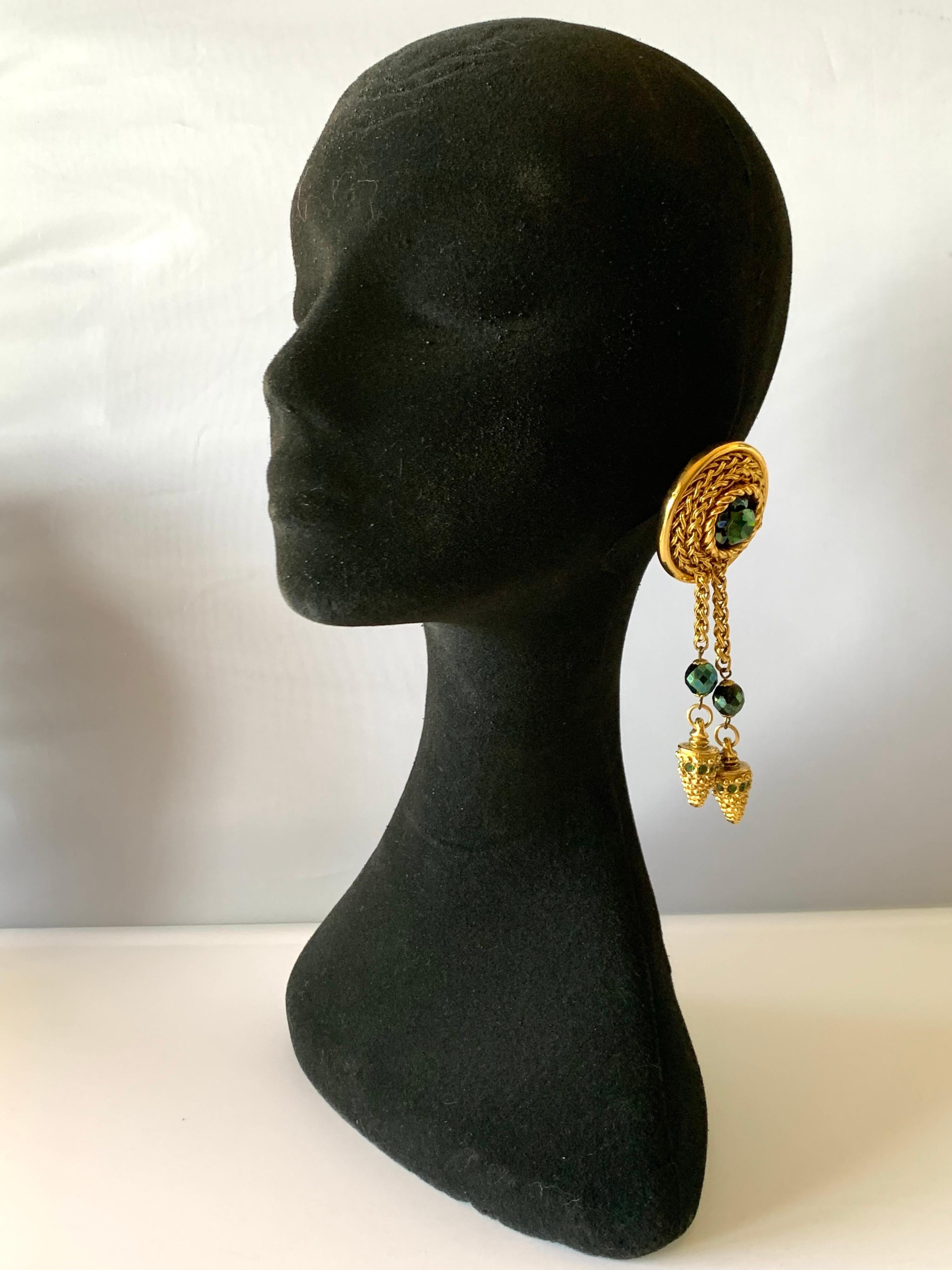 Sensational vintage gilt knotted French statement clip-on earrings circa 1980 - comprised of gilt metal segments encrusted with faux emerald stones and long tassels, signed Claire Deve, Paris. The illustrious designer also designed pieces for