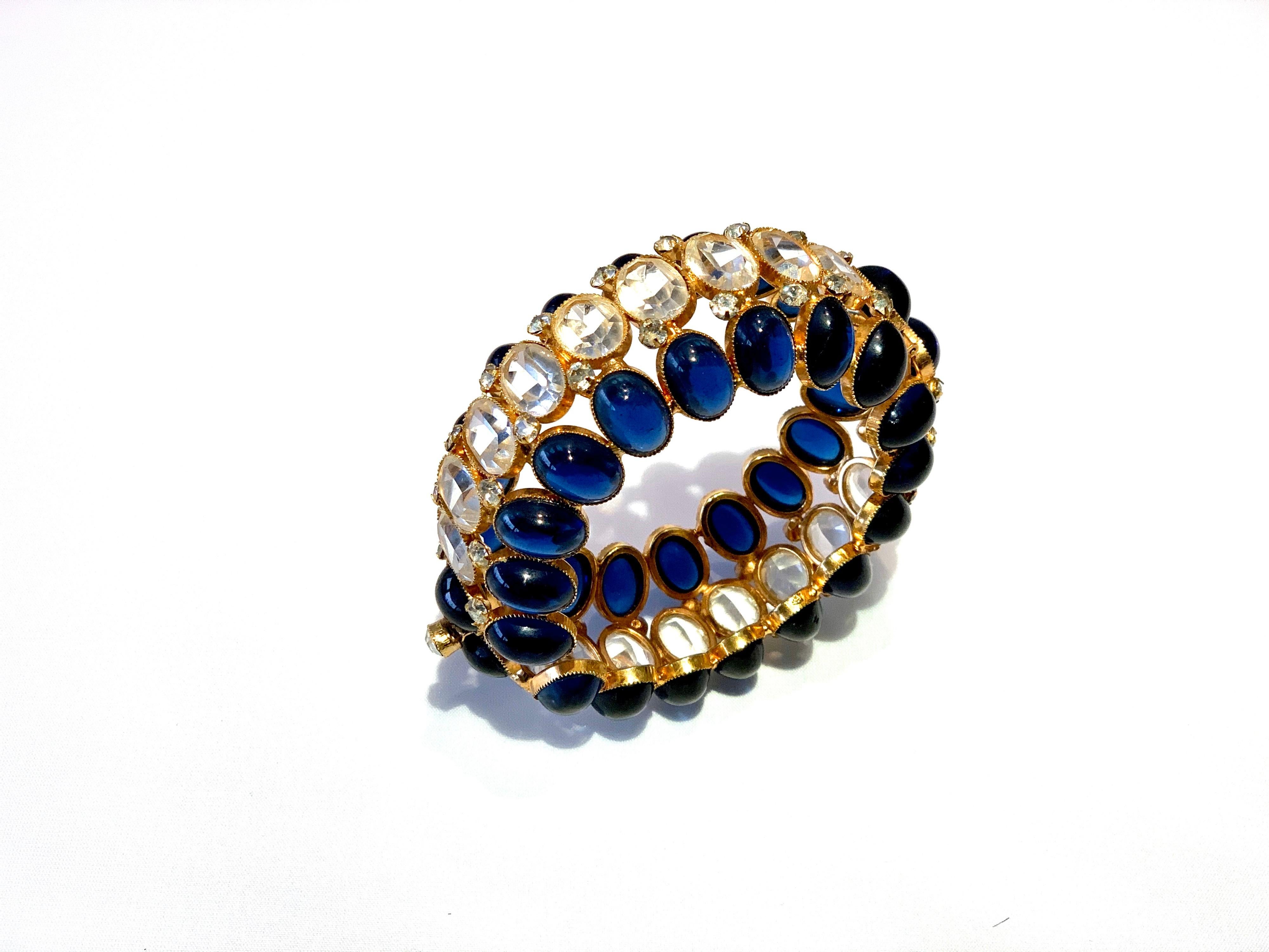 Vintage dramatic haute couture gilt sapphire diamante statement bangle/clamper bracelet - exquisitely crafted out of gilt metal and features three rows of stones. The top and bottom rows are covered by large faux sapphire oval cabochons - the center