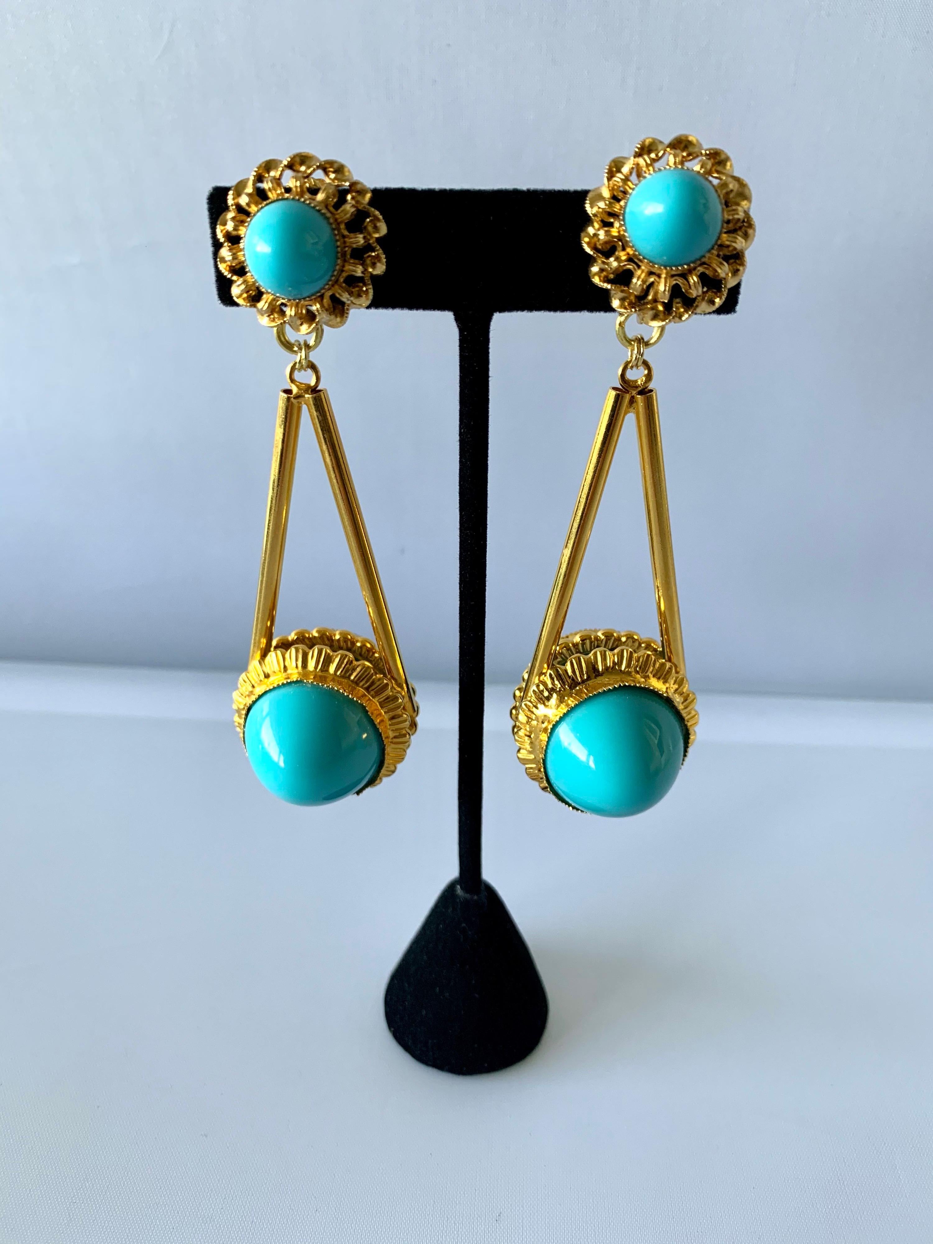 Vintage architectural chandelier clip-on earrings comprised out gilt-metal adorned by large turquoise glass cabochons, designed by William de Lillo circa 1970 for American Fashion designer Bill Blass.