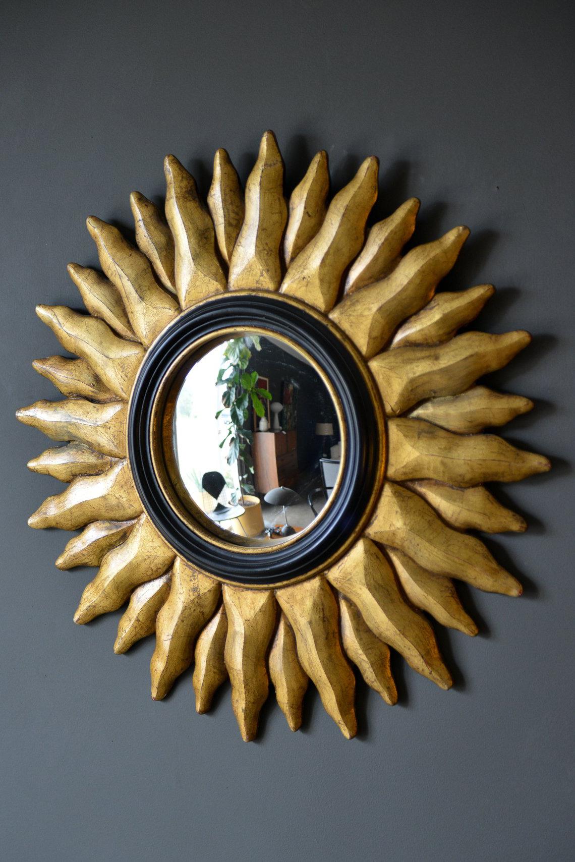 Vintage giltwood convex sunburst mirror, circa 1970. Beautiful gold gilt to the wood and a vintage convex mirror, trimmed in a black border in very good vintage condition. Heavy piece, which is indicative of the age of the mirror and wood. Measures: