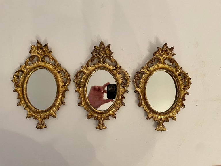 Great vintage matched set of three Hollywood Regency style giltwood italian florentine mirrors. Good condition with newly replaced mirrors. Each measures 9