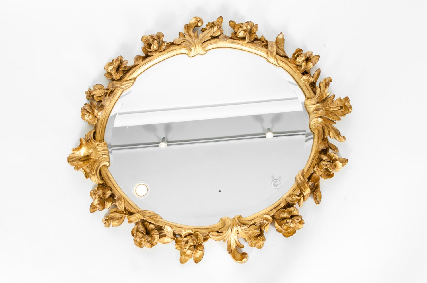 Mid-20th century giltwood framed round wreath bevelled hanging mirror. The mirror is in excellent condition . The mirror measure about 29 inches long x 26 inches width.