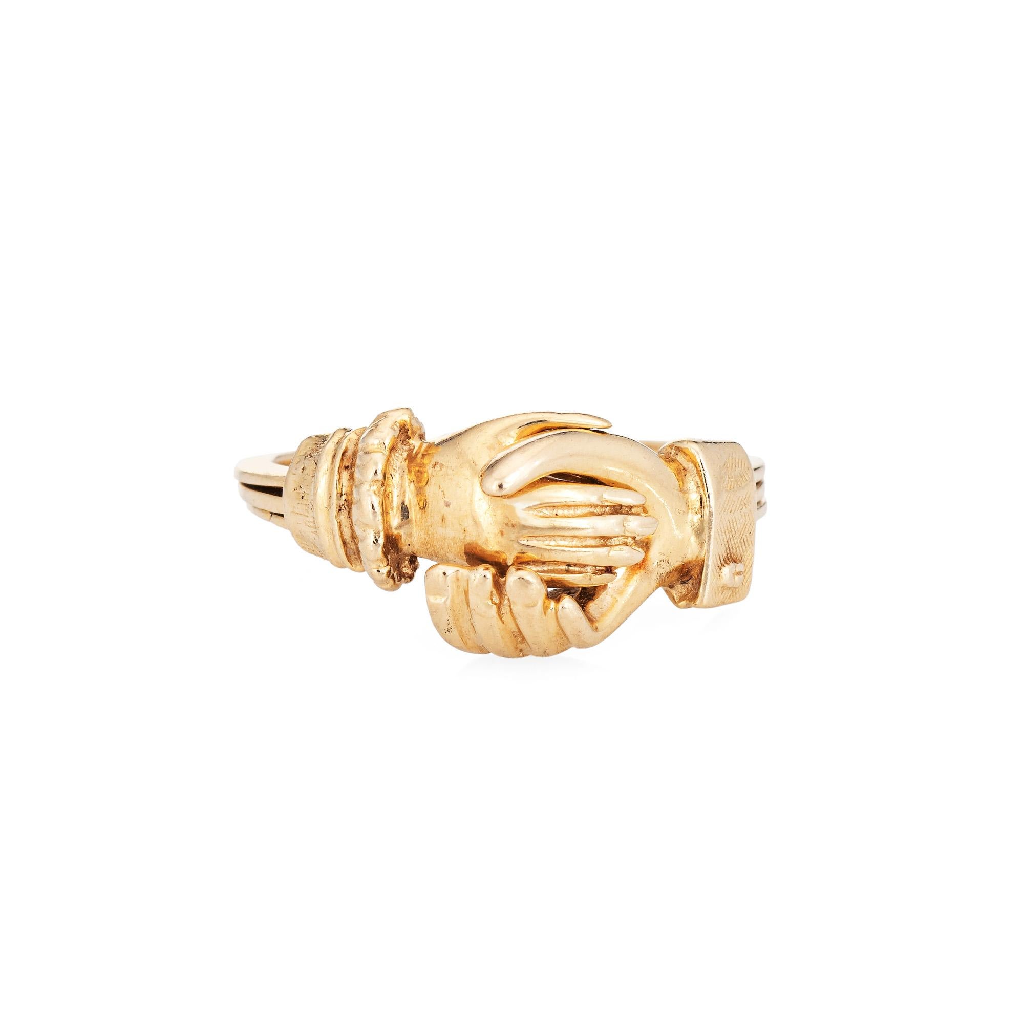 Stylish vintage Gimmal ring crafted in 14 karat yellow gold. 

Gimmel rings have been popular for centuries, with the holding hands symbolizing eternal love and loyalty. The interlocking bands represent an unbreakable union. The hands 'open' to