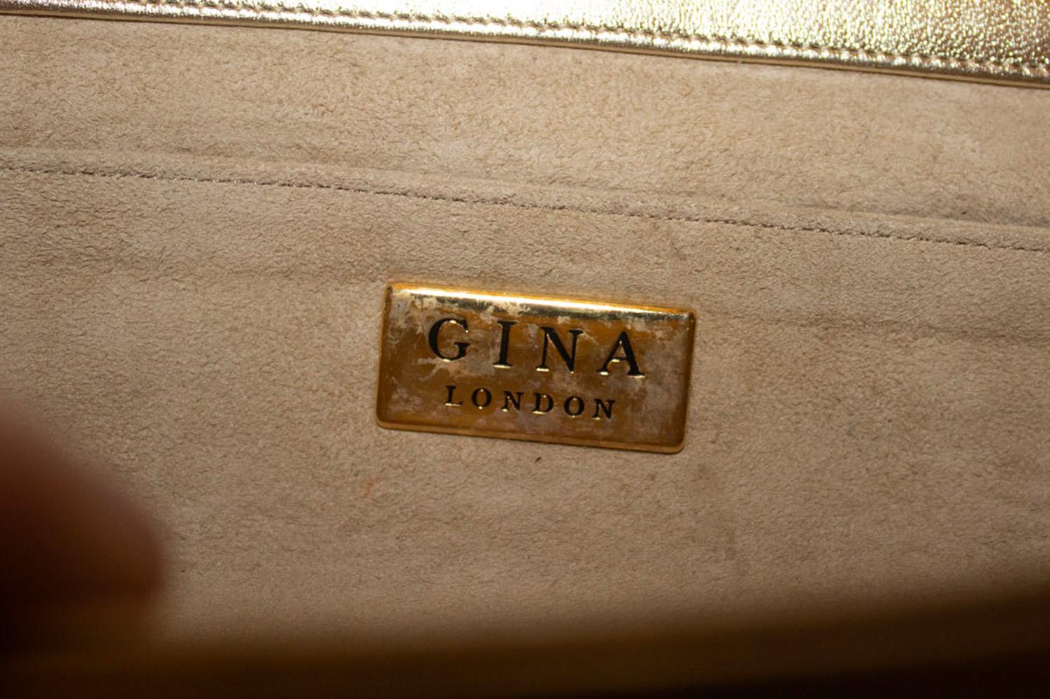 A stunning vintage evening bag by Gina. The bag can either be worn as a clutch or a shoulder bag as it has a chain that can be tucked in. It is gold leather with diamante buckle detail. 
It is lined in suede , with an internal pouch pocket and has a