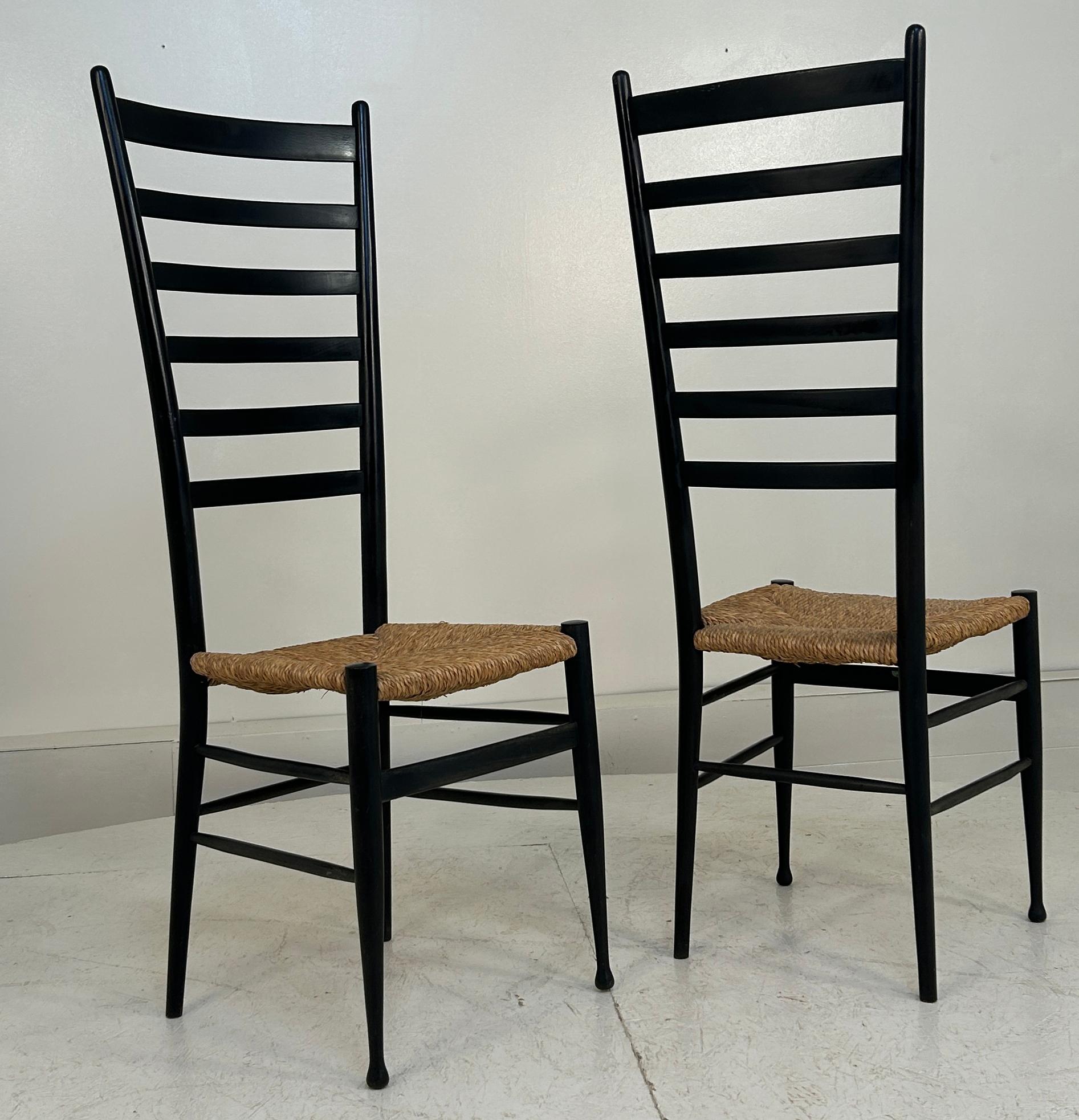 Signed Made in Italy to both examples. Set of 2  Italian Mid-Century Modern Dining Chairs in the Style of Gio Ponti  Elevate your dining experience with these elegant, Italian-made wooden ladder back chairs, inspired by the iconic Gio Ponti. With