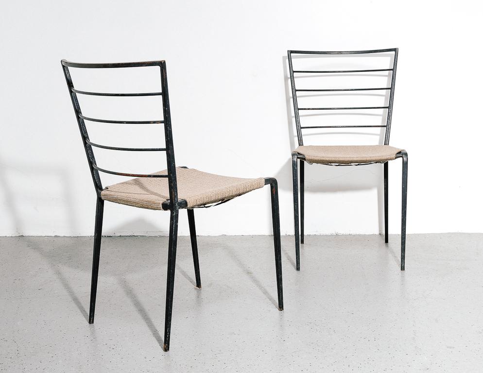 Vintage modern indoor or outdoor chairs in black painted steel. Tan fabric upholstery stretched over the frame with cord. Perhaps inspired by the designs of Gio Ponti.

Measures: 17.25