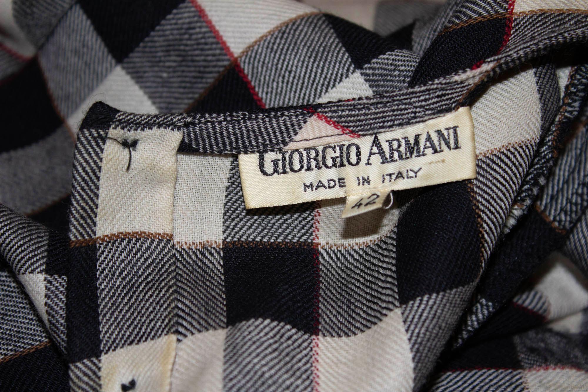 A fun vintage blouse by Giorgio Armani, in brown , black and white check top. It has an interesting button opening on one side  and a three button opening at the back . It has single button cuffs. Size Italian 42, Bust 36/7'', length 23''