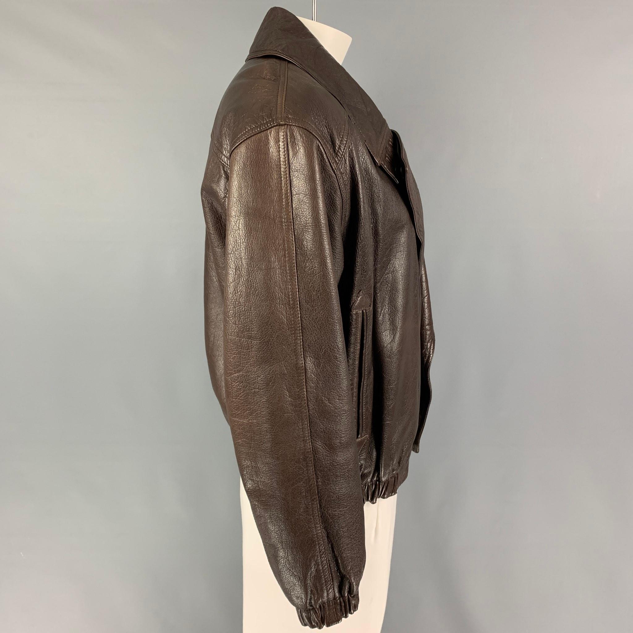Vintage GIORGIO ARMANI jacket comes in a brown leather featuring a large lapel, slit pockets, elastic hem, and a single breasted closure. 

Good Pre-Owned Condition. Light wear. As-Is.
Marked: Size tag removed.

Measurements:

Shoulder: 22.5